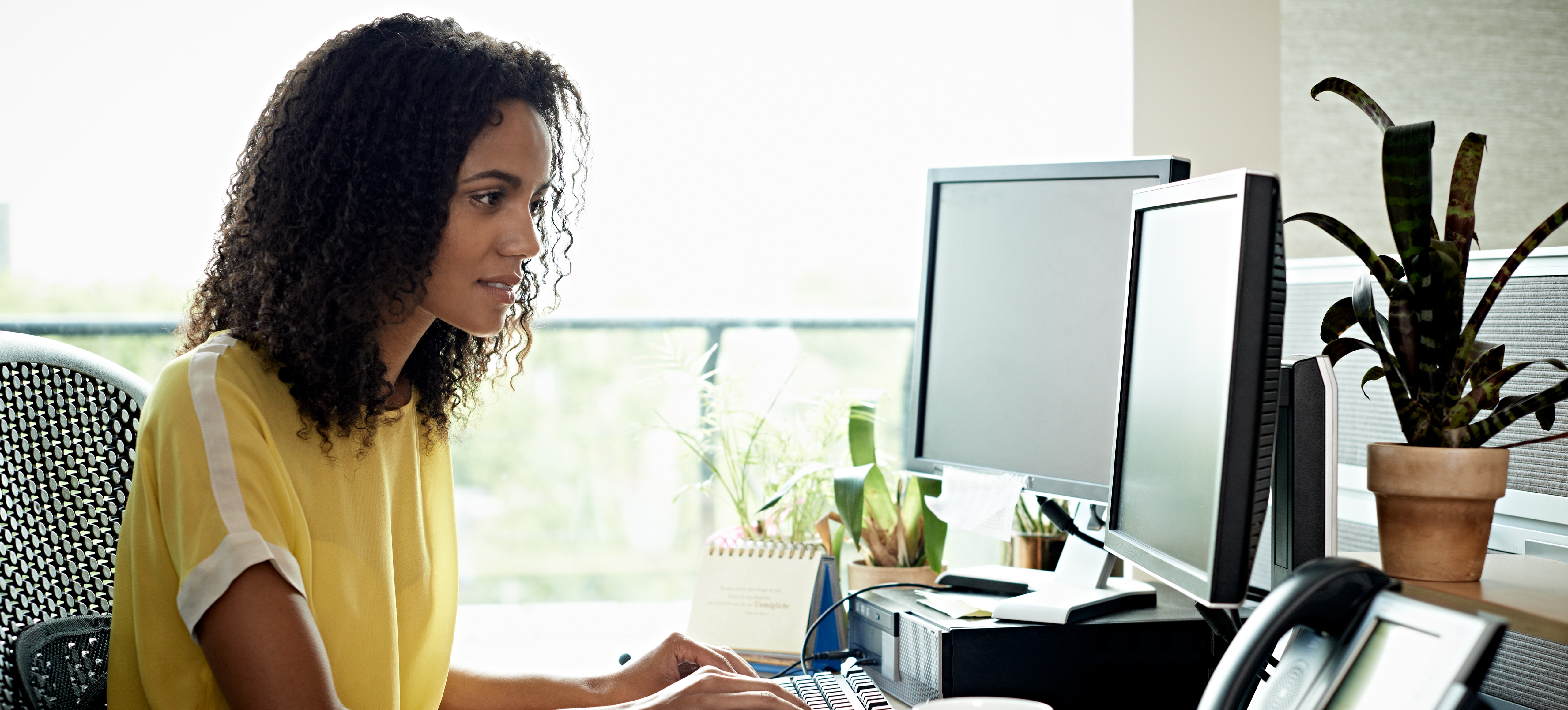[Featured Image] An employee composes a resignation letter for an employer.
