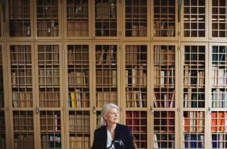 [Featured Image] A forensic accountant is going over an investigation in their library.