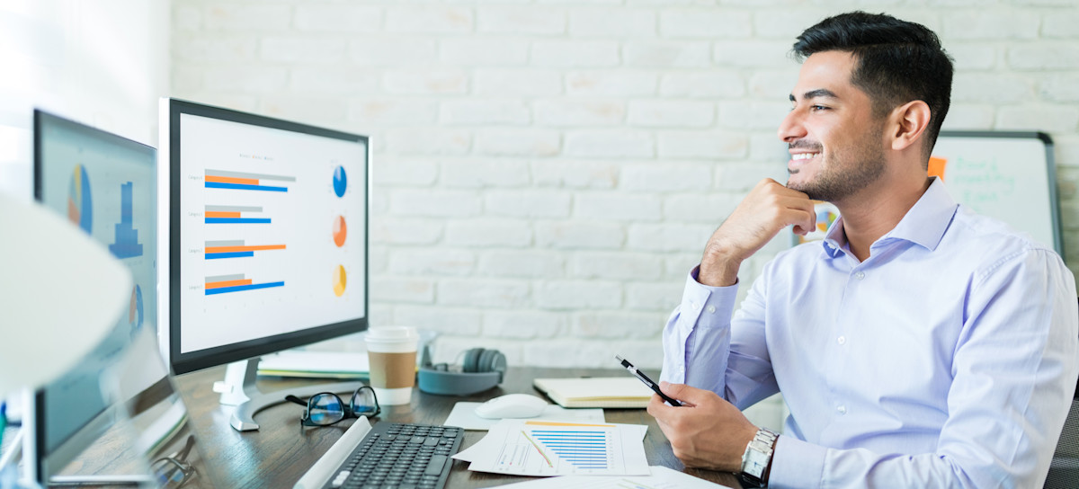 [Featured Image] A Tableau developer creates a presentation at their computer.
