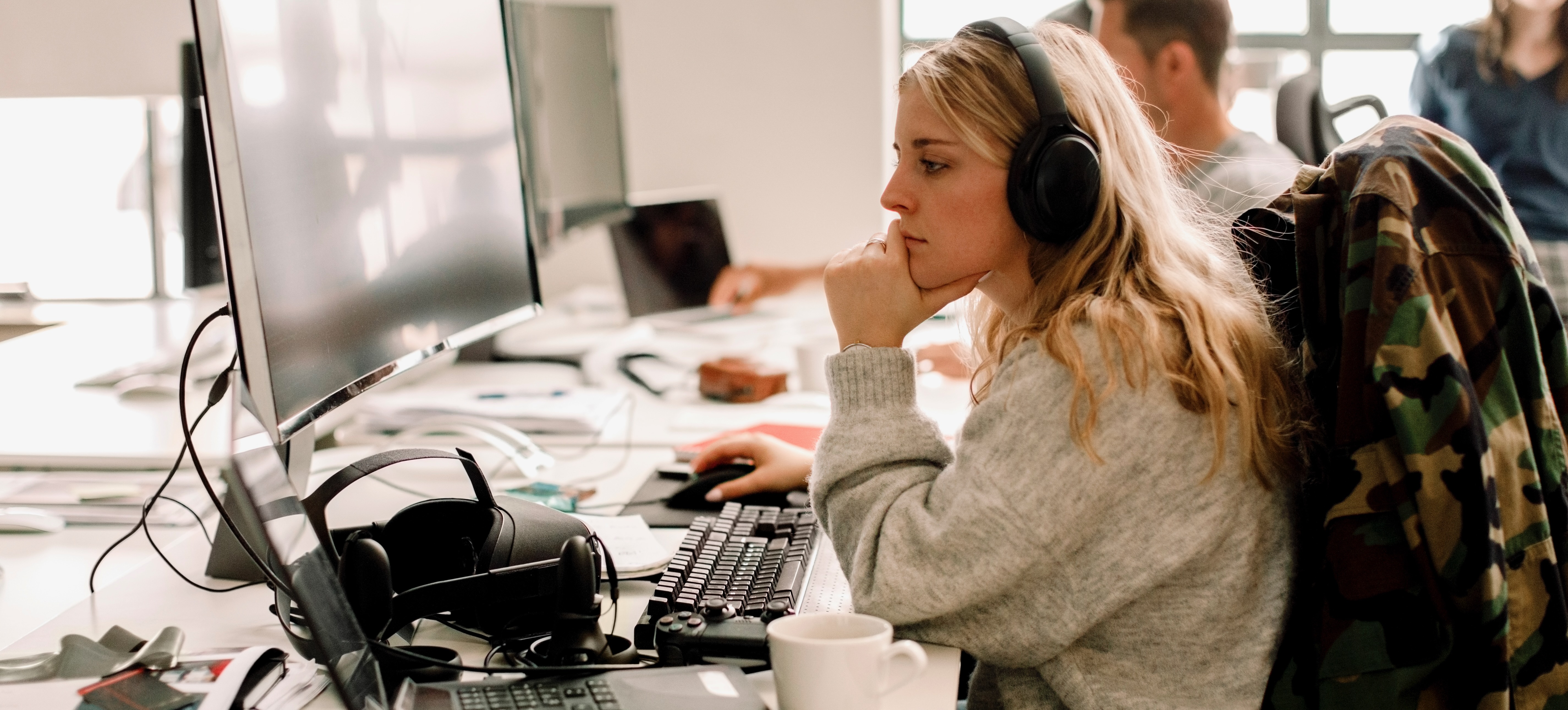 [Image en vedette] Un ingénieur de l'assistance technique porte des écouteurs et travaille à son bureau pour résoudre les problèmes techniques et de réseau des clients.
