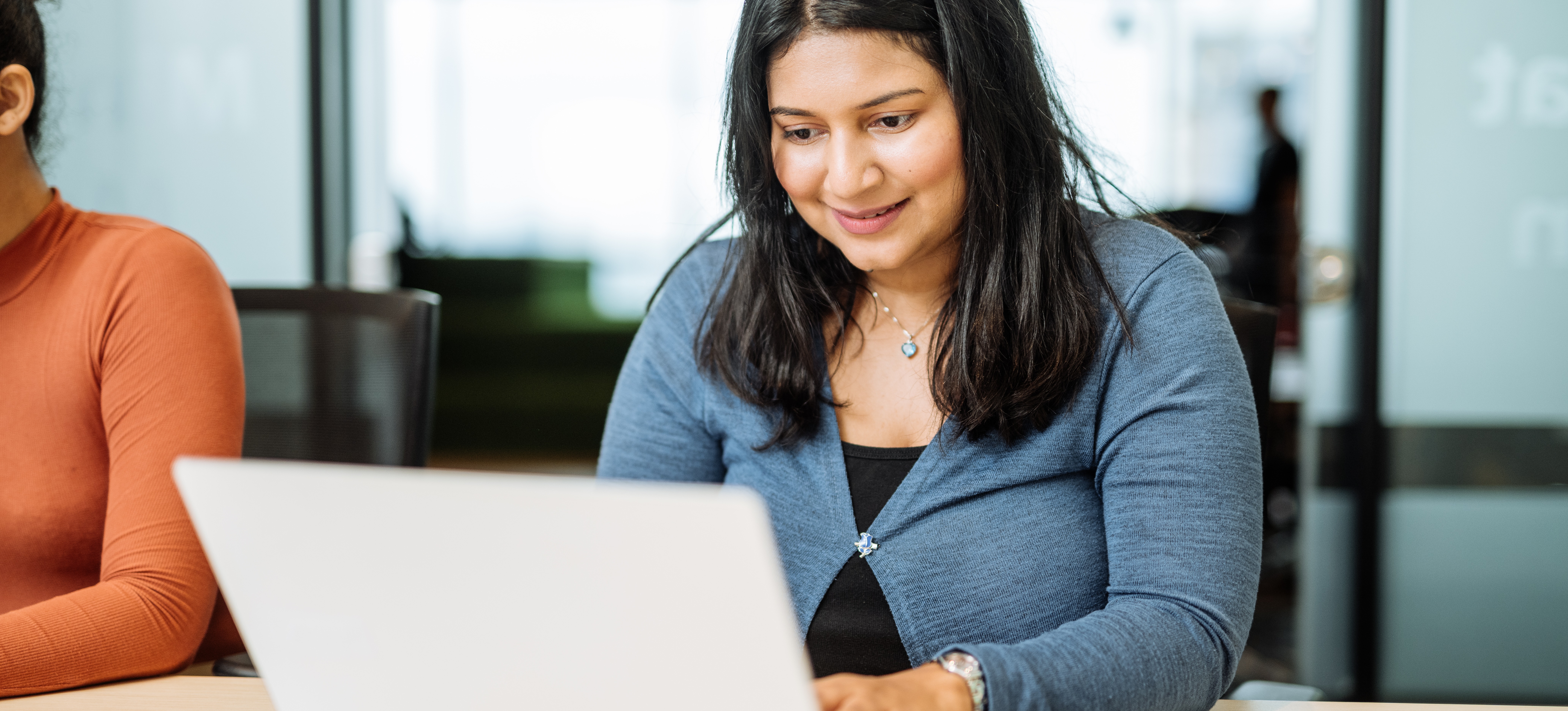 [Featured image] IT professional in a modern office using hashing in data structure to support fast retrieval of information. 