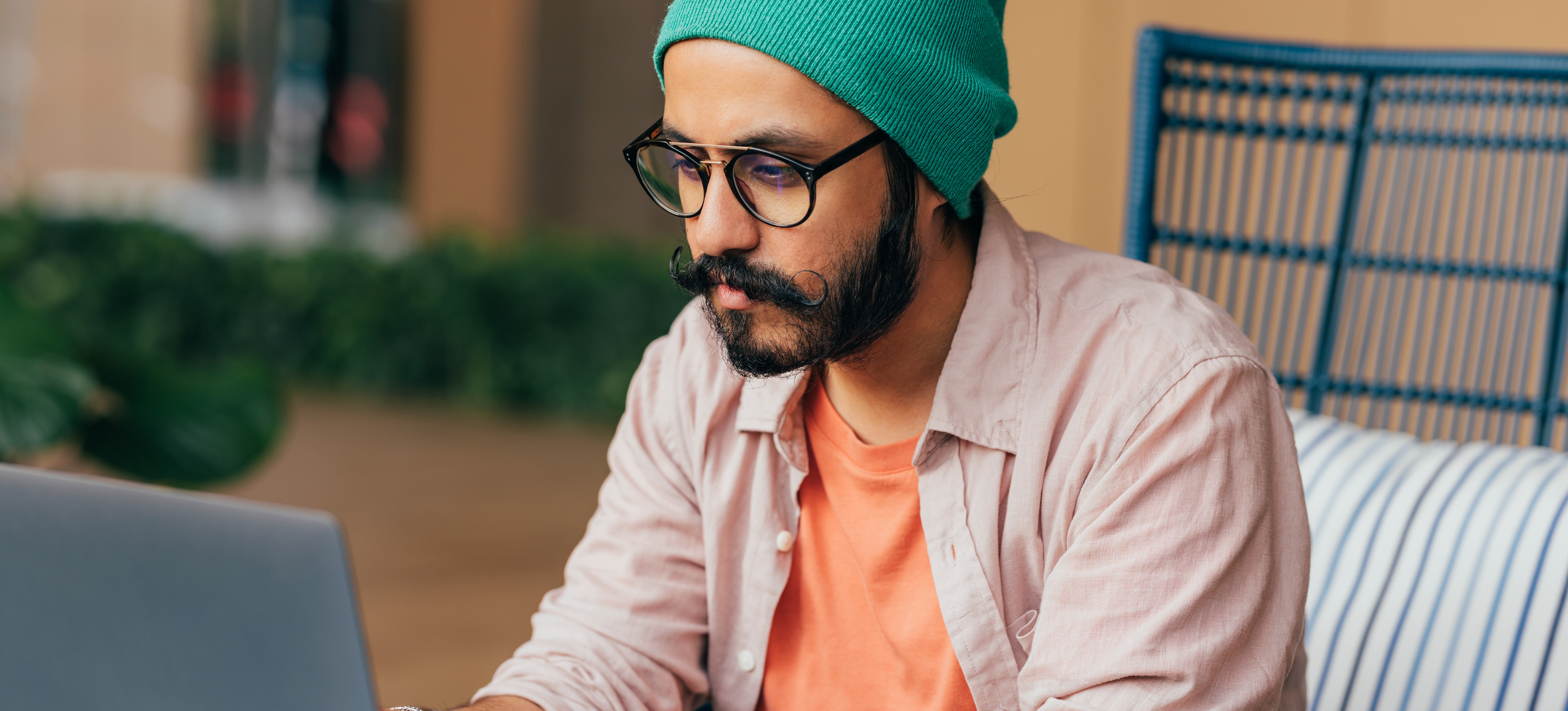 [Featured Image] An aspiring developer researches the average software developer's salary as they plan their career path and education. 
