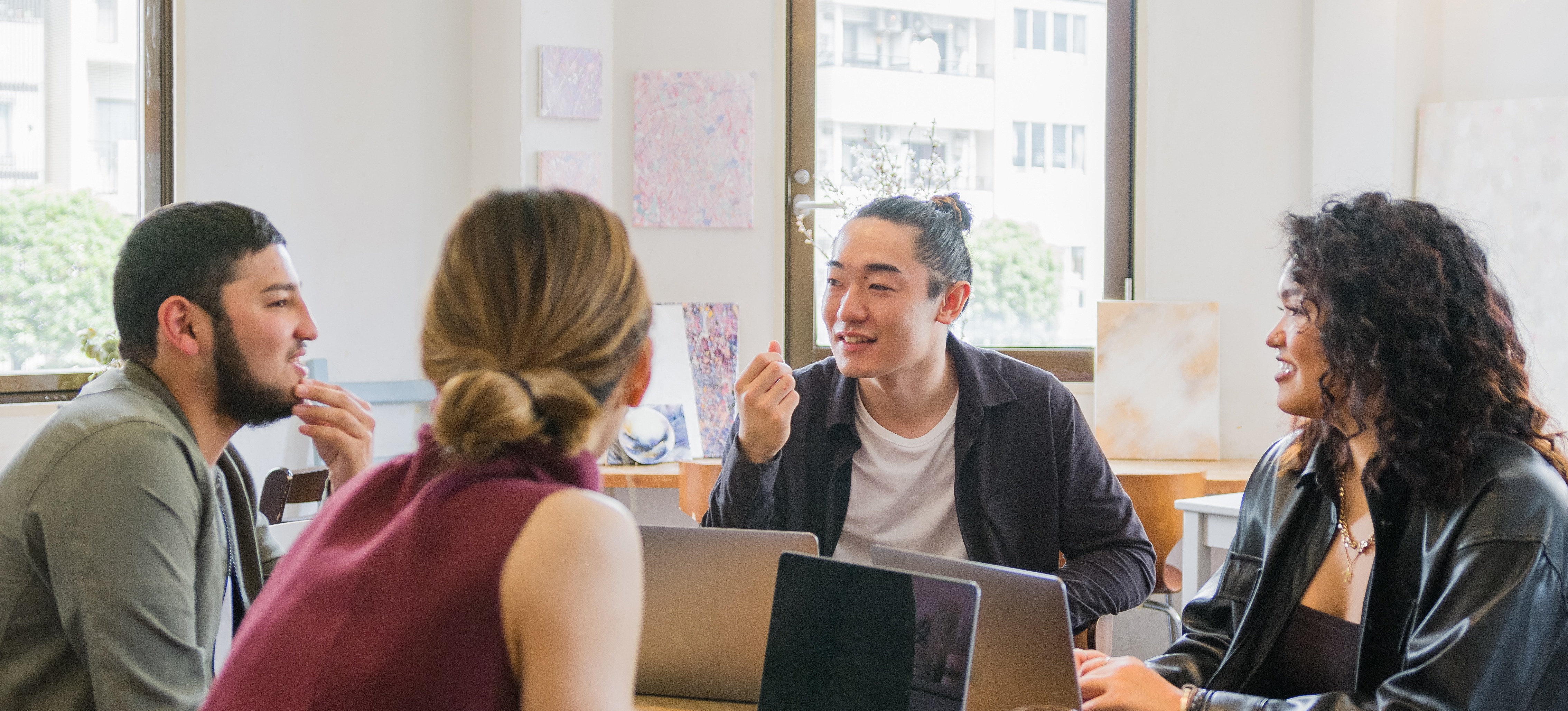 [Featured Image] Four members of a DevOps team discuss their CI/CD pipeline and how to refine the team’s overall strategy. 
