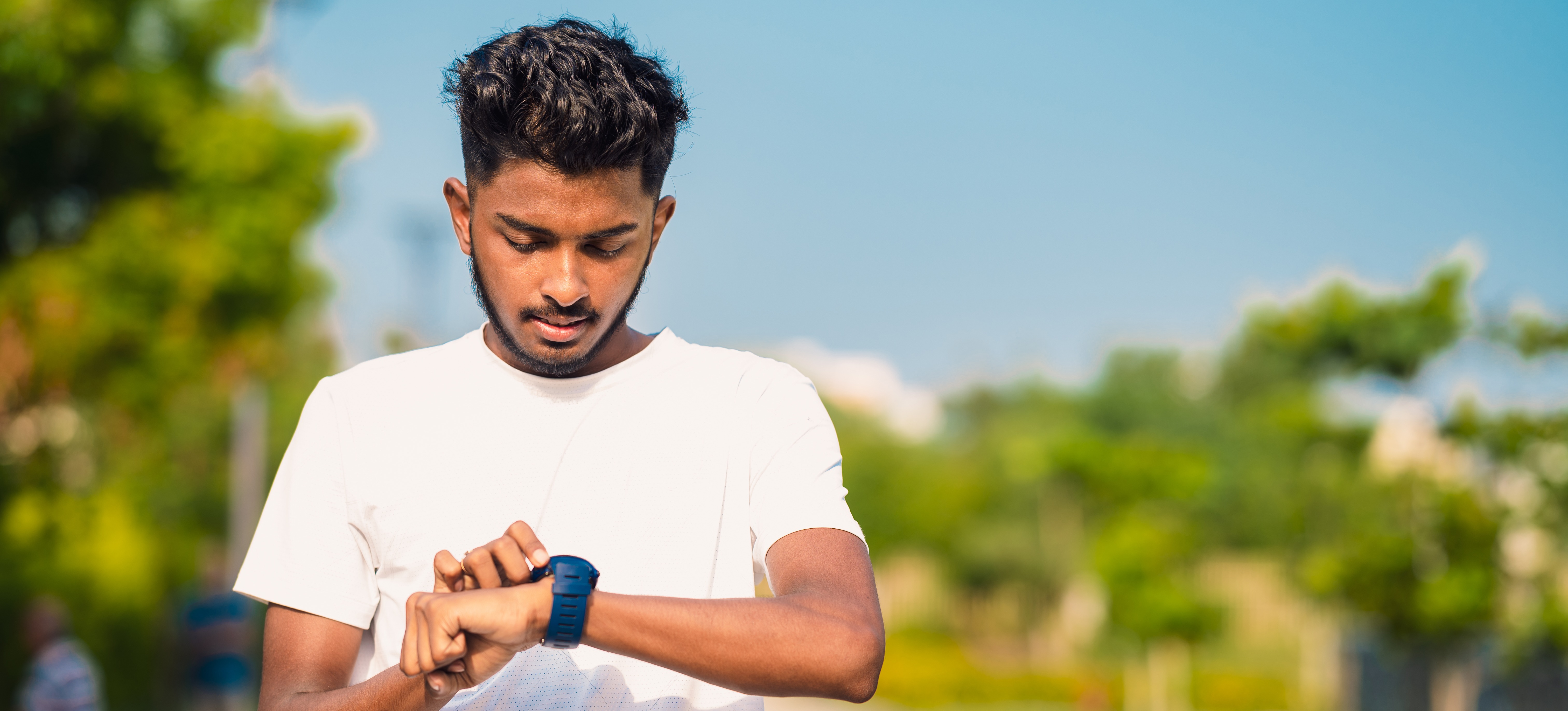 [Featured Image]: A person looks at his watch as they practise using time management skills.
