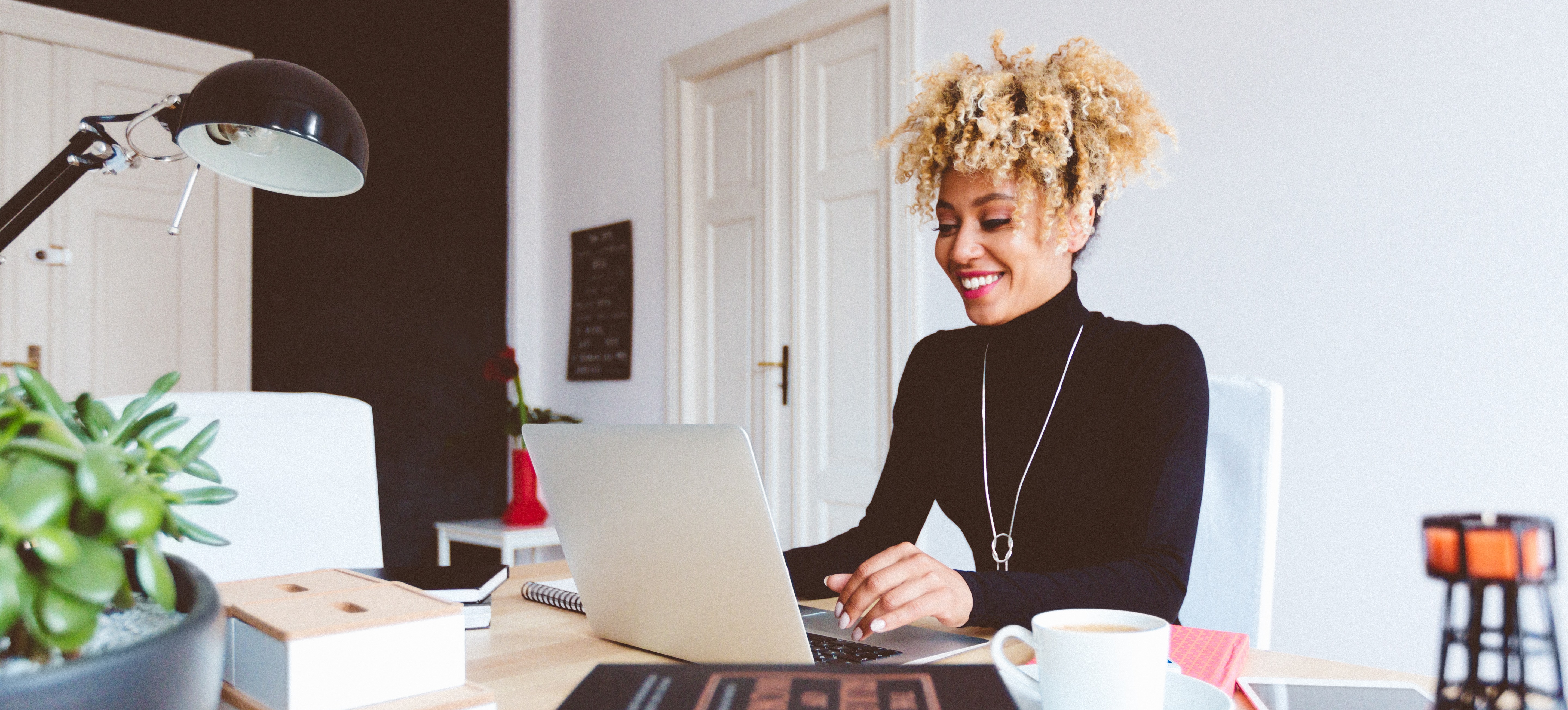 [Featured Image] A woman sits at a laptop researching the differences between Perplexity and ChatGPT.