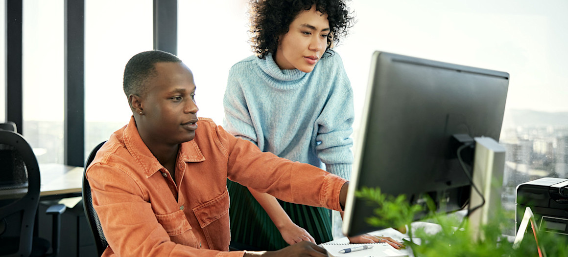 [Featured image] Two co-workers troubleshoot a formula parse error in Google Sheets.