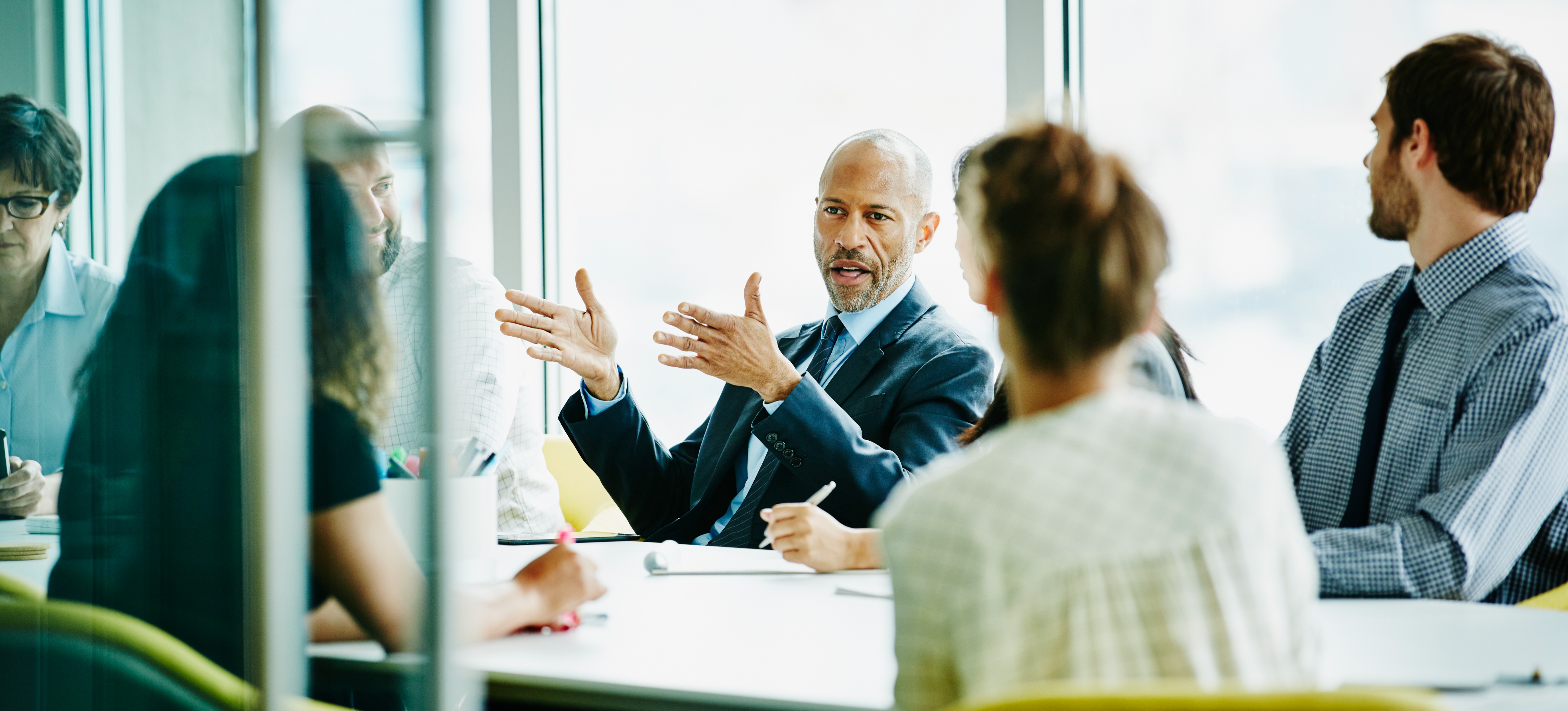 [Features Image] A business intelligence consultant is meeting with an organization's leaders and discussing the data that was collected.