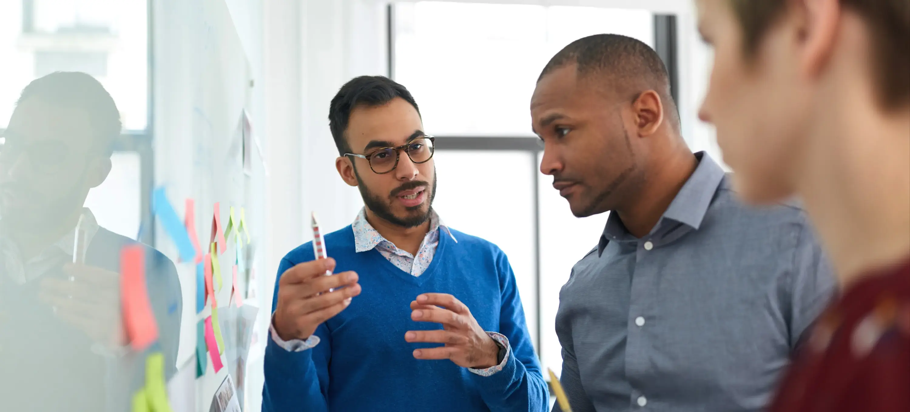 [Featured Image]: A product marketing team puts their skills to use as they review a plan for an upcoming product launch.
