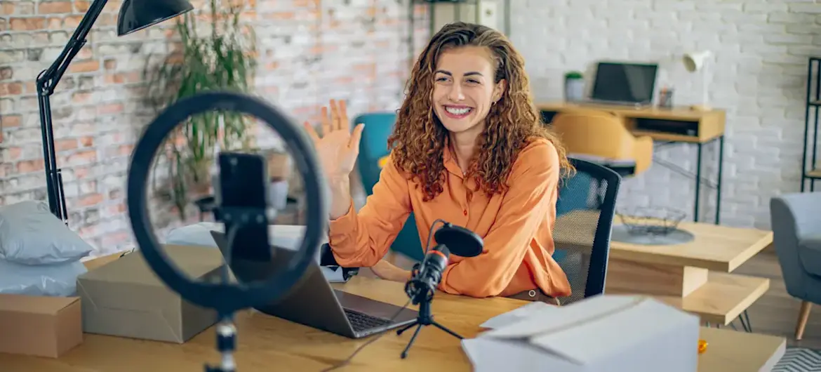 [Featured Image] A person follows social media best practices as they record social media content for their brand.
