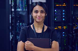 [Featured image] An ethical hacker is standing in an electrical room while holding a laptop to their chest. 