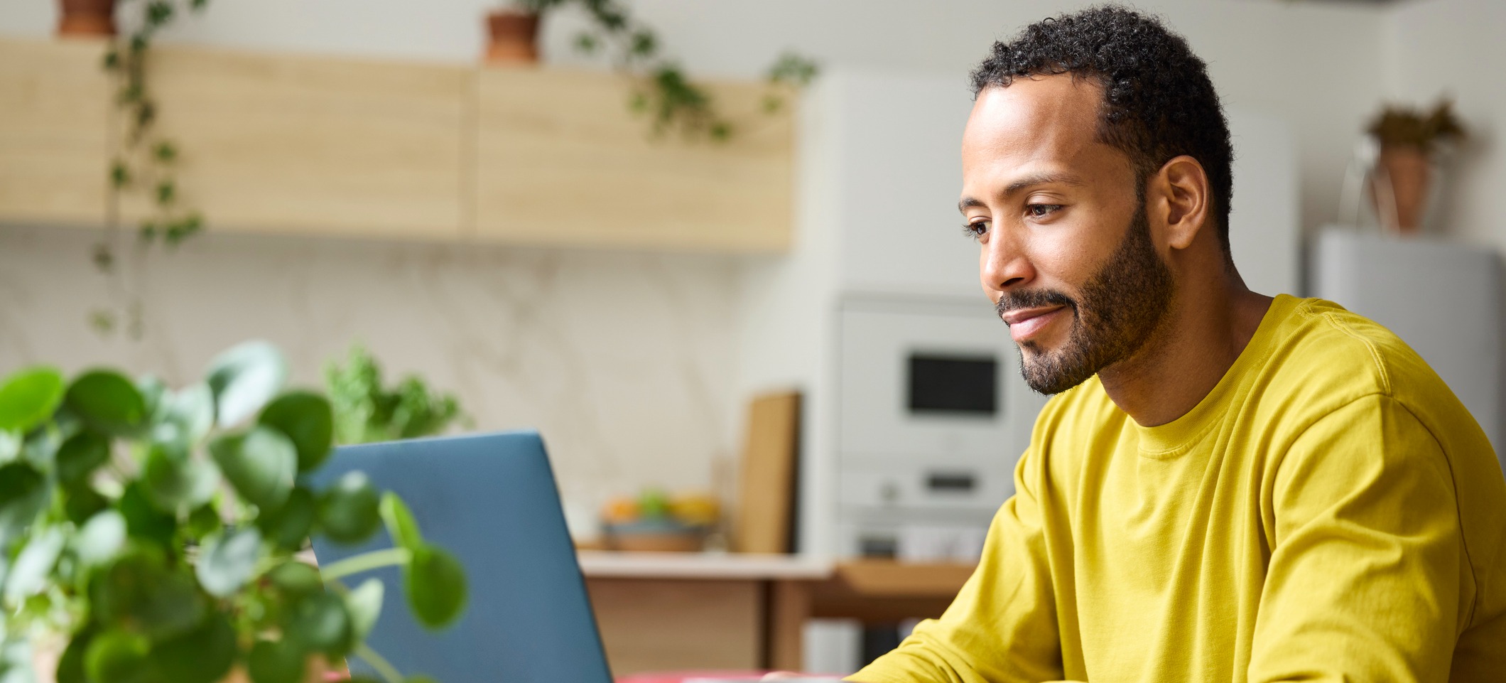 [Featured Image] A freelancer works with ChatGPT plugin alternatives on their laptop at home.
