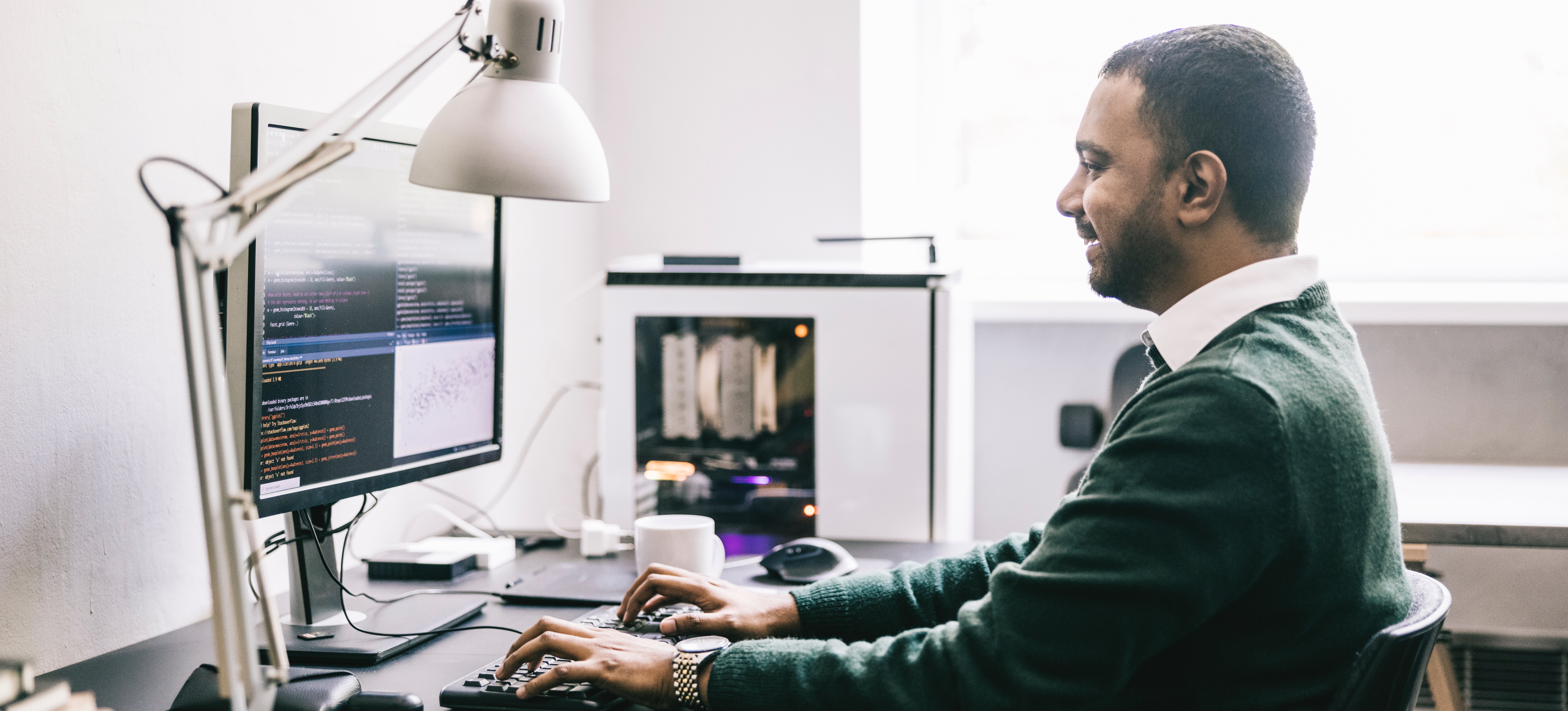 [Featured Image]: A programmer sits at their computer in their home office, working with a front-end framework.

