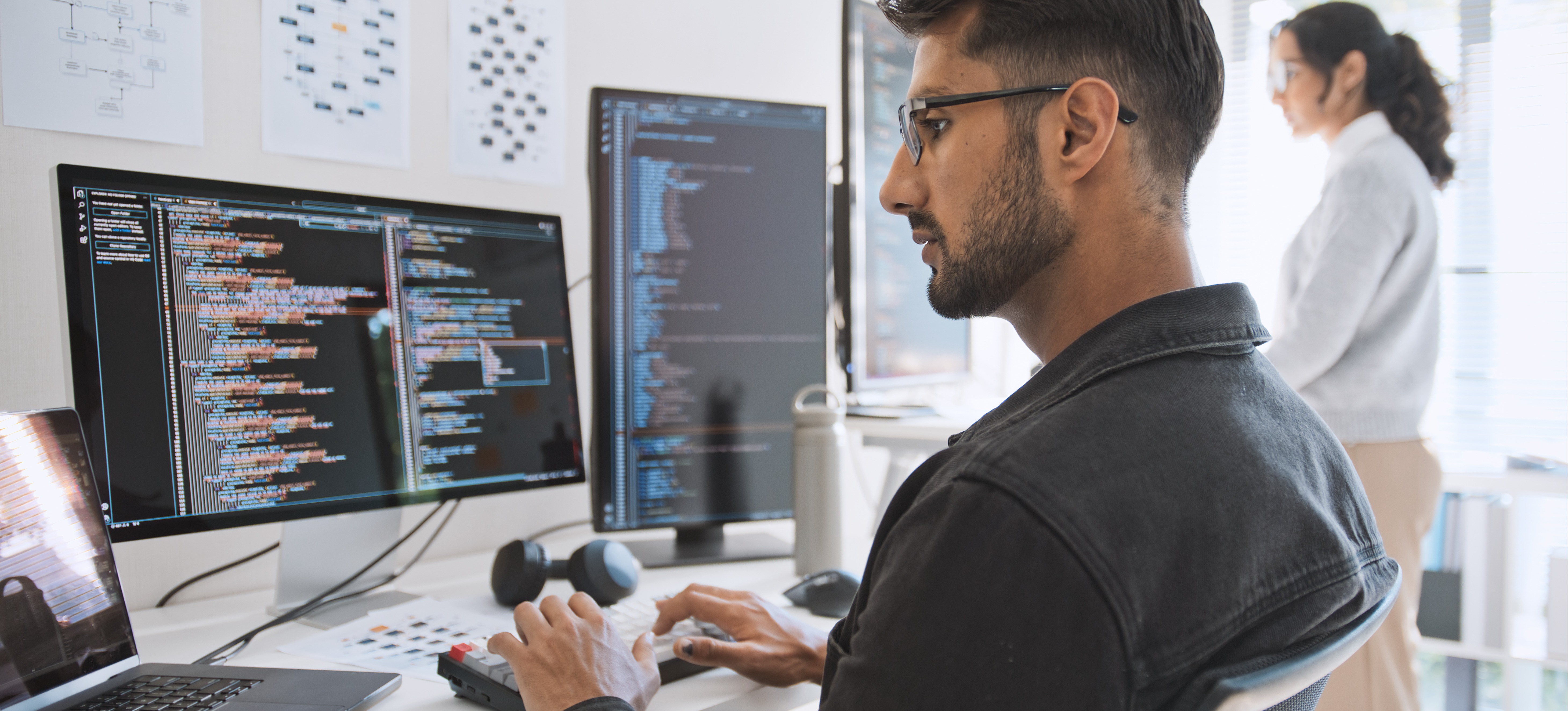 [Featured Image] After choosing the best way to learn Ruby, a programmer practices their new skills while working on a computer and coding in Ruby in a professional workspace.
