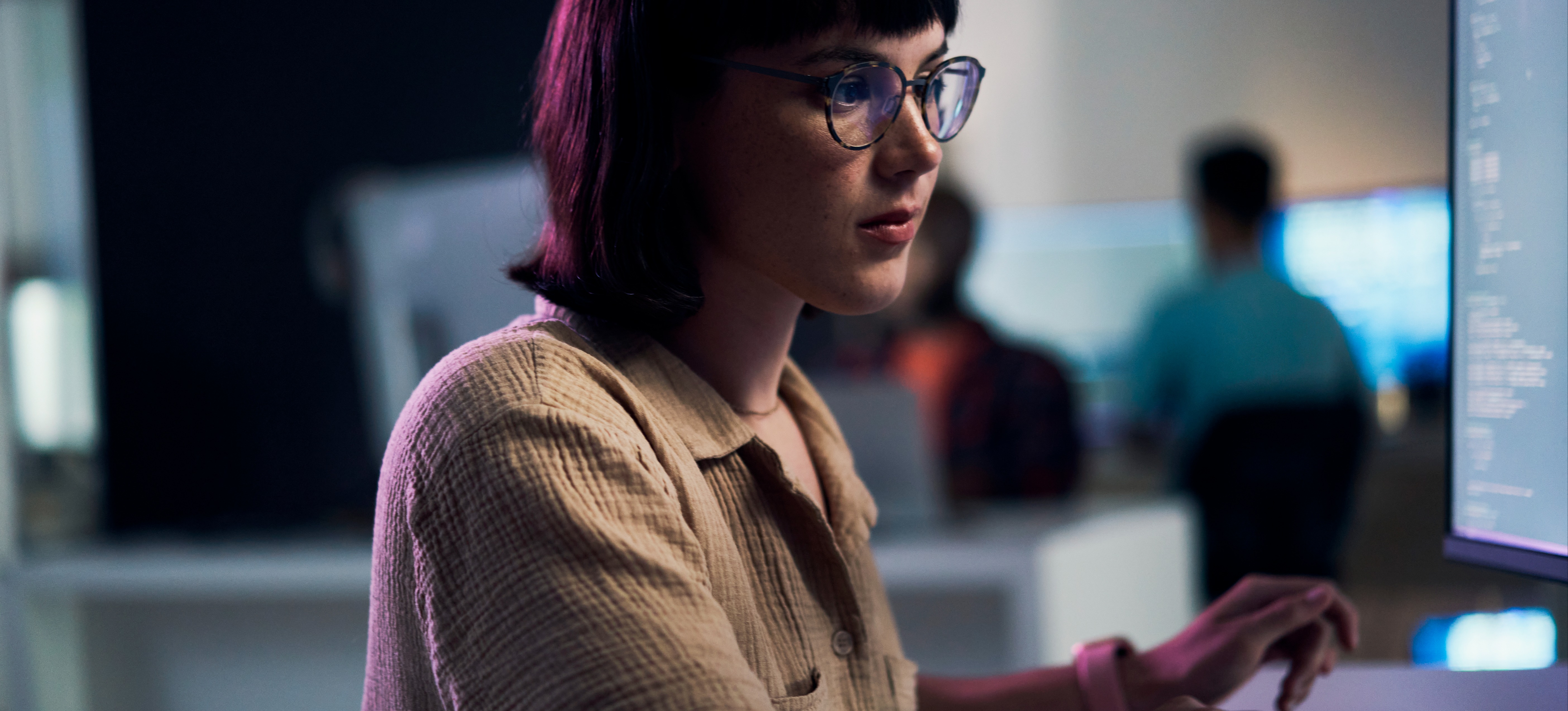 [Featured Image] A professional working in an office environment, focusing on HTML coding on their computer to enhance their web development skills.