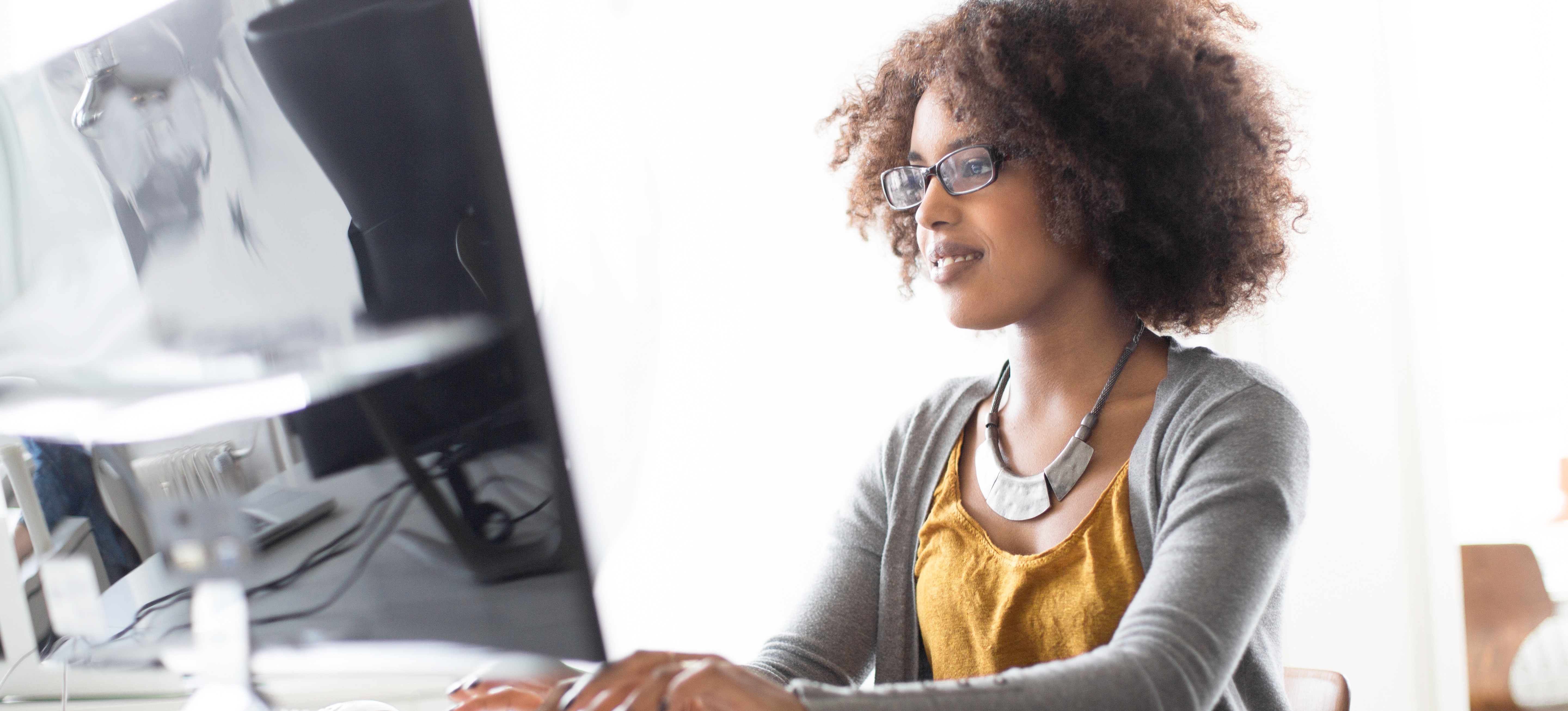 [Featured Image] A video game developer works on her laptop using Lua programming as a scripting language.
