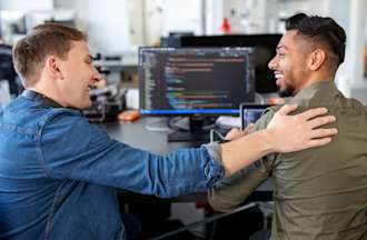 [Featured Image] An IT project manager works with an IT professional while reviewing a software project in their office.