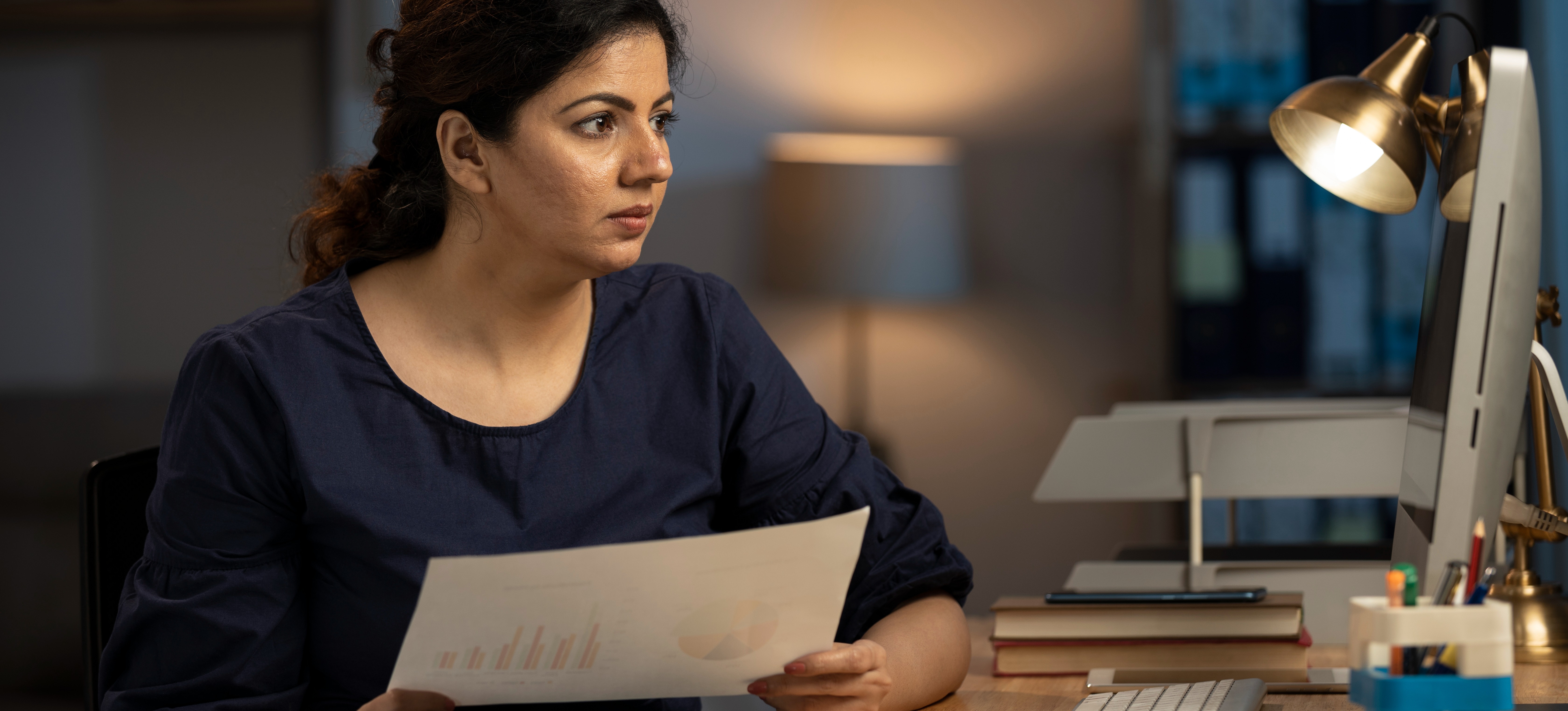 [Featured image] A student in their home office studies for a master’s in data analytics. 
