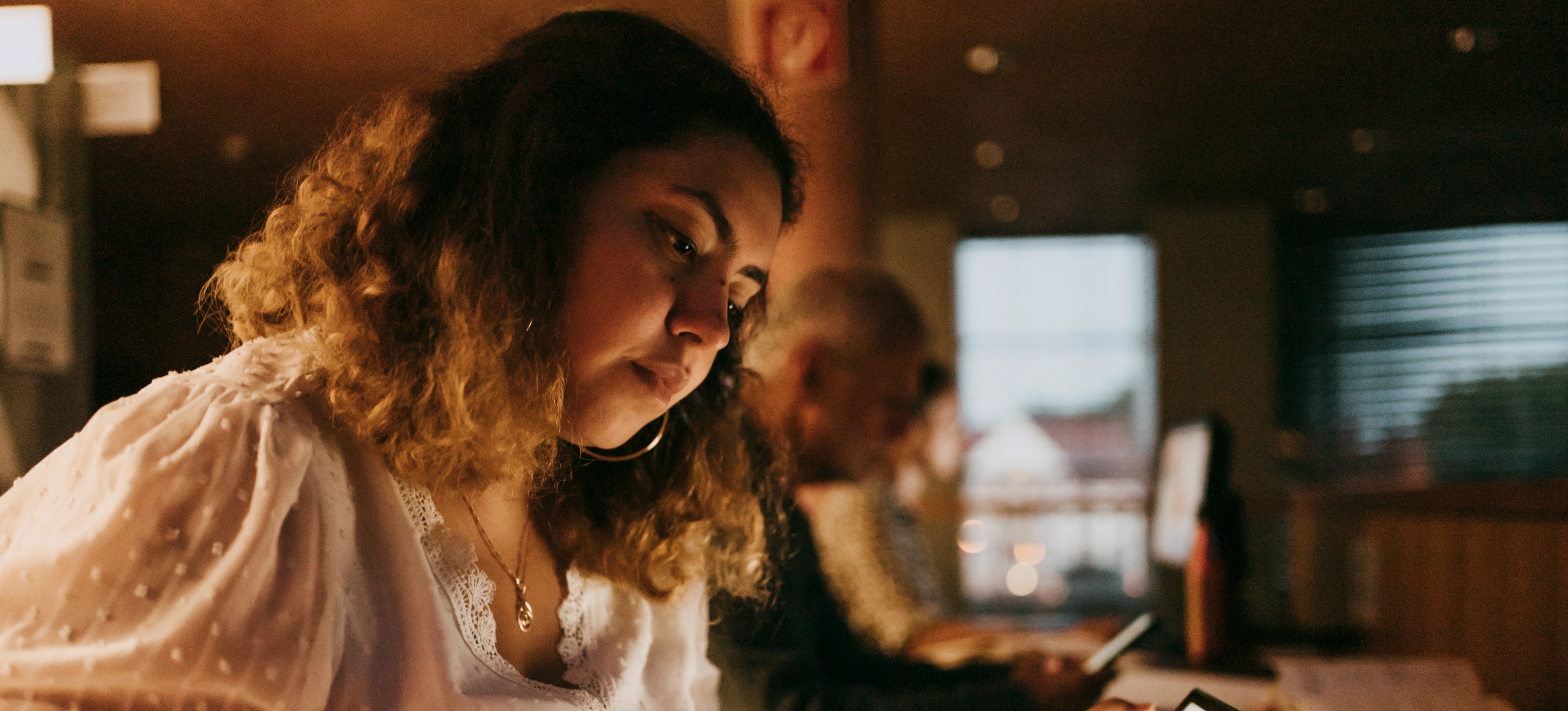 [Featured image] A person in a computer lab using tech to build new skills after a RIF. 
