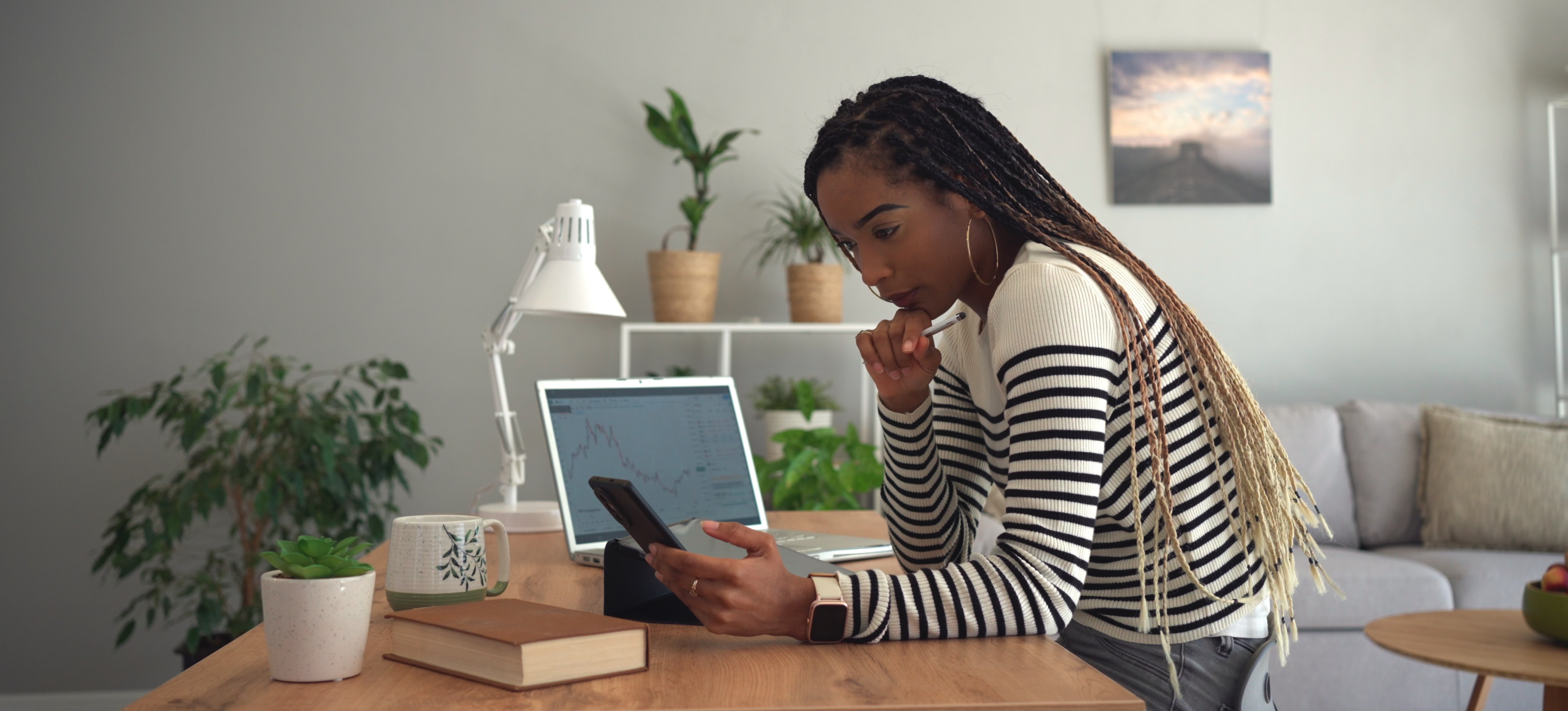 [Image en vedette] Un analyste de données est assis dans son bureau à domicile et utilise l'analyse IA sur ses appareils.
