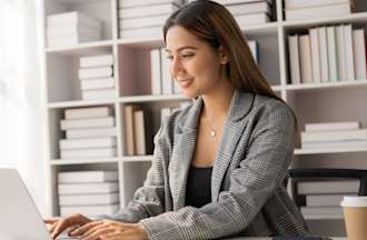 [Featured Image] A data scientist sits at a desk with a laptop and relies on clustering to gain insights. 
