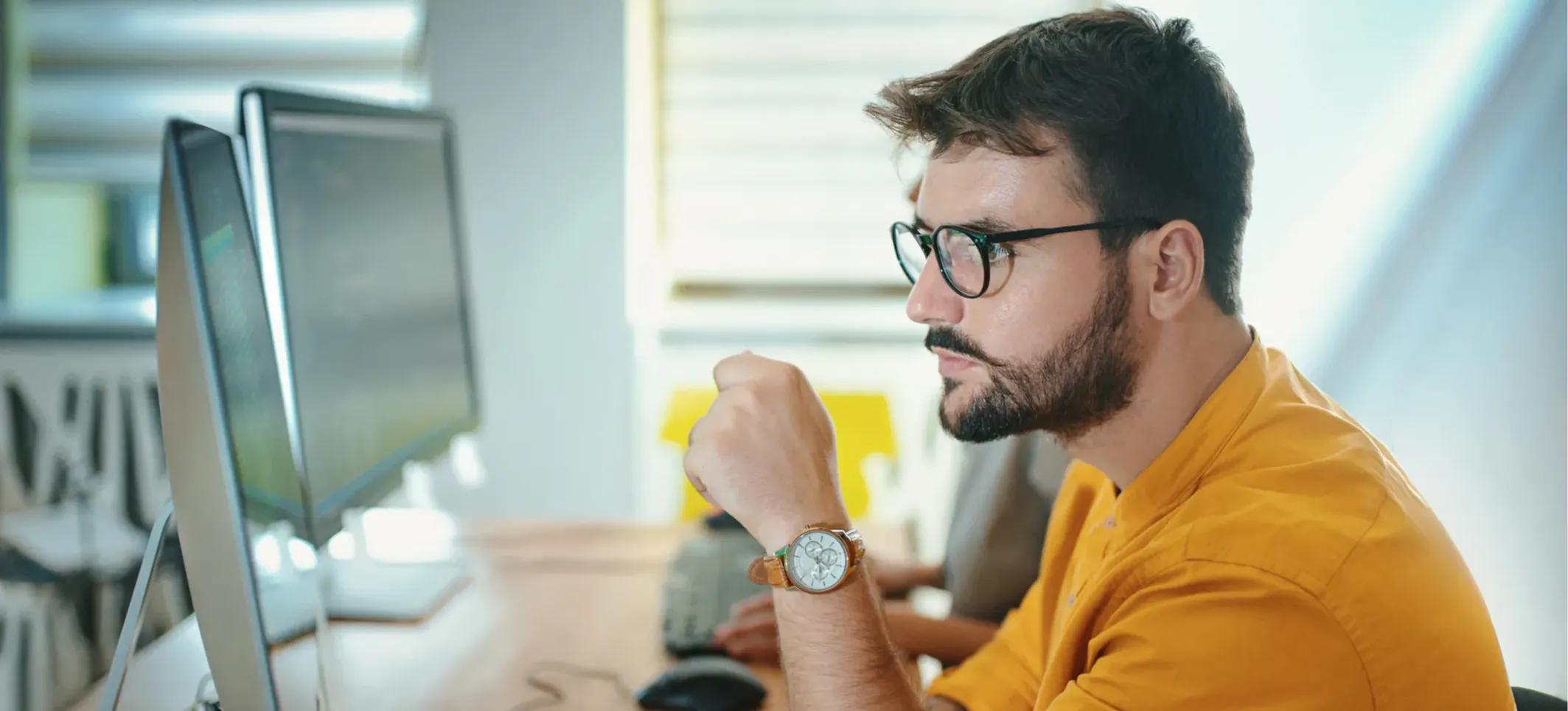[Featured Image] Side view of a software developer using AI, such as Claude Sonnet, to resolve issues with the code they are working on.
