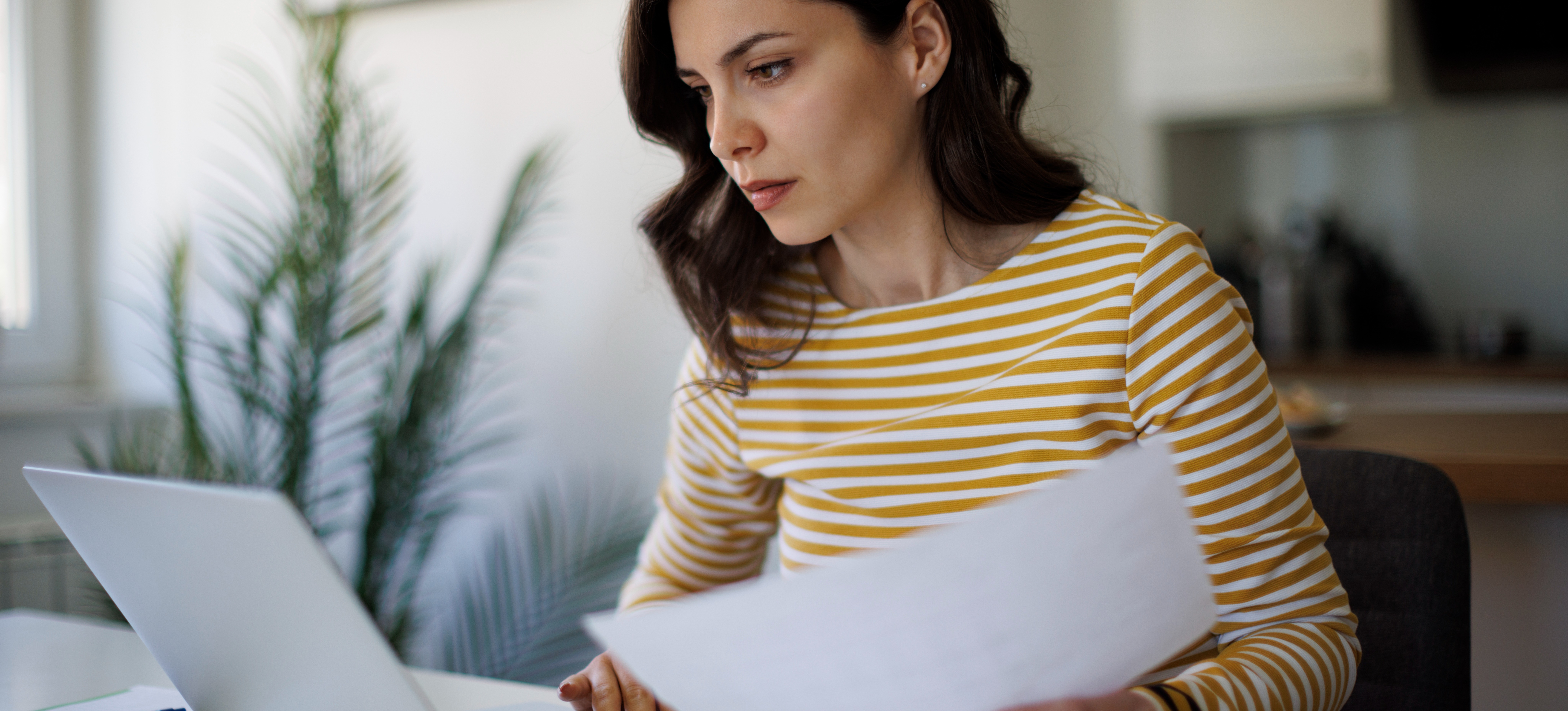 [Featured image] Tax analyst working at a computer from home.