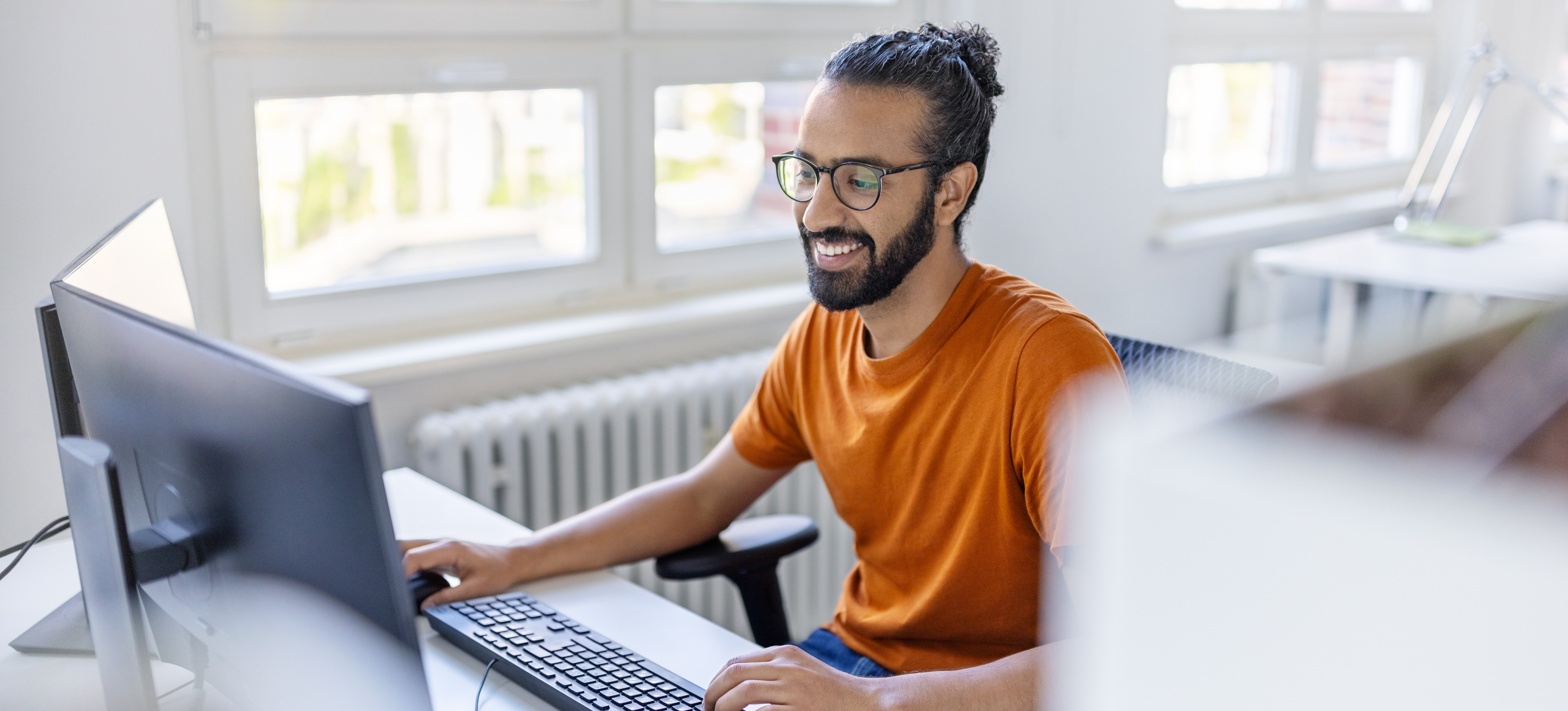 [Featured Image] A prompt engineer is at their computer practicing essential prompt engineering skills, including learning C++, a new computer language.
