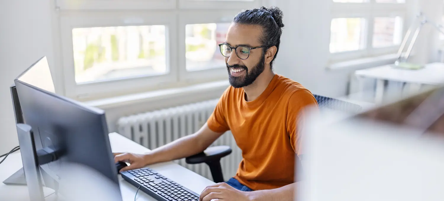 [Featured Image] A prompt engineer is at their computer practicing essential prompt engineering skills, including learning C++, a new computer language.
