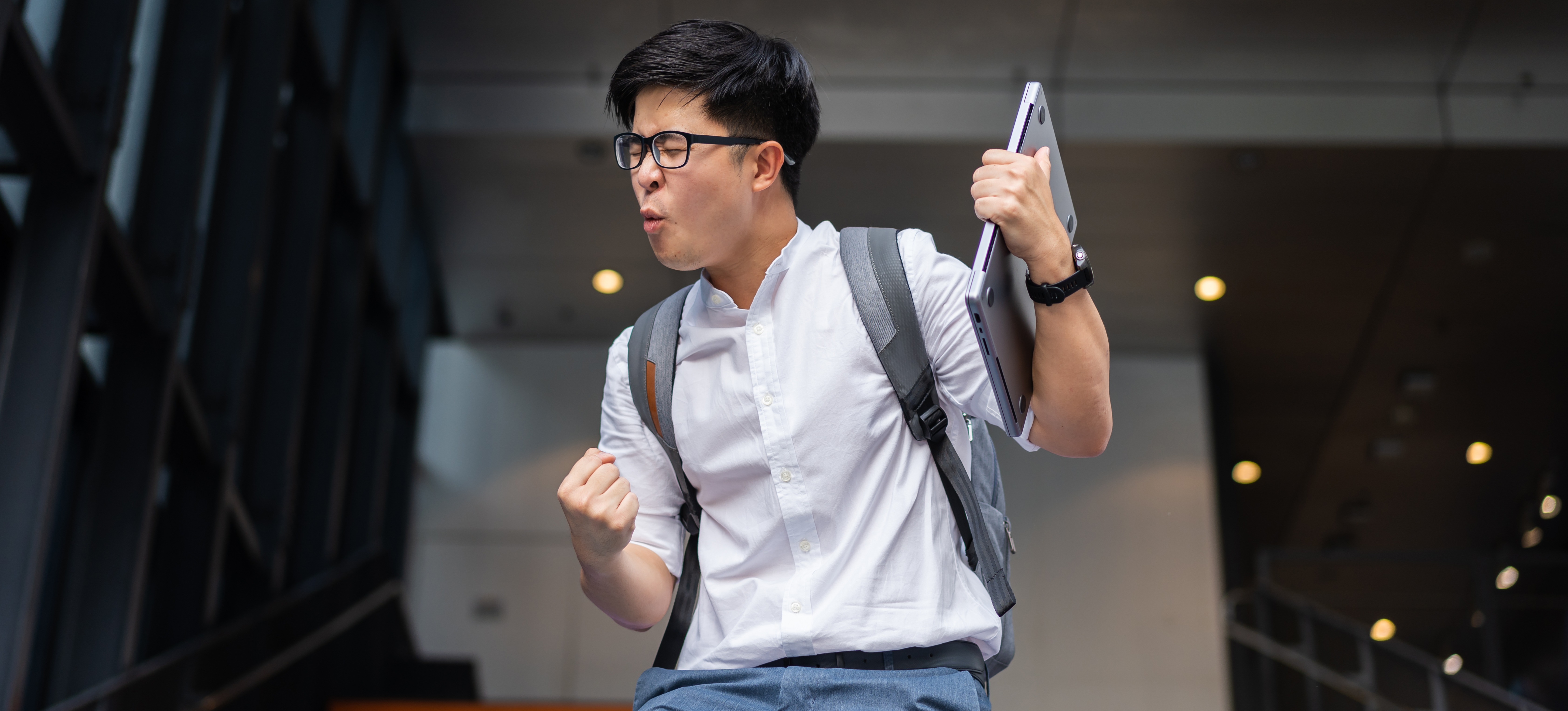 [Featured Image] A learner who will soon graduate walks down colorful stairs and celebrates after learning how to get a job fast. 
