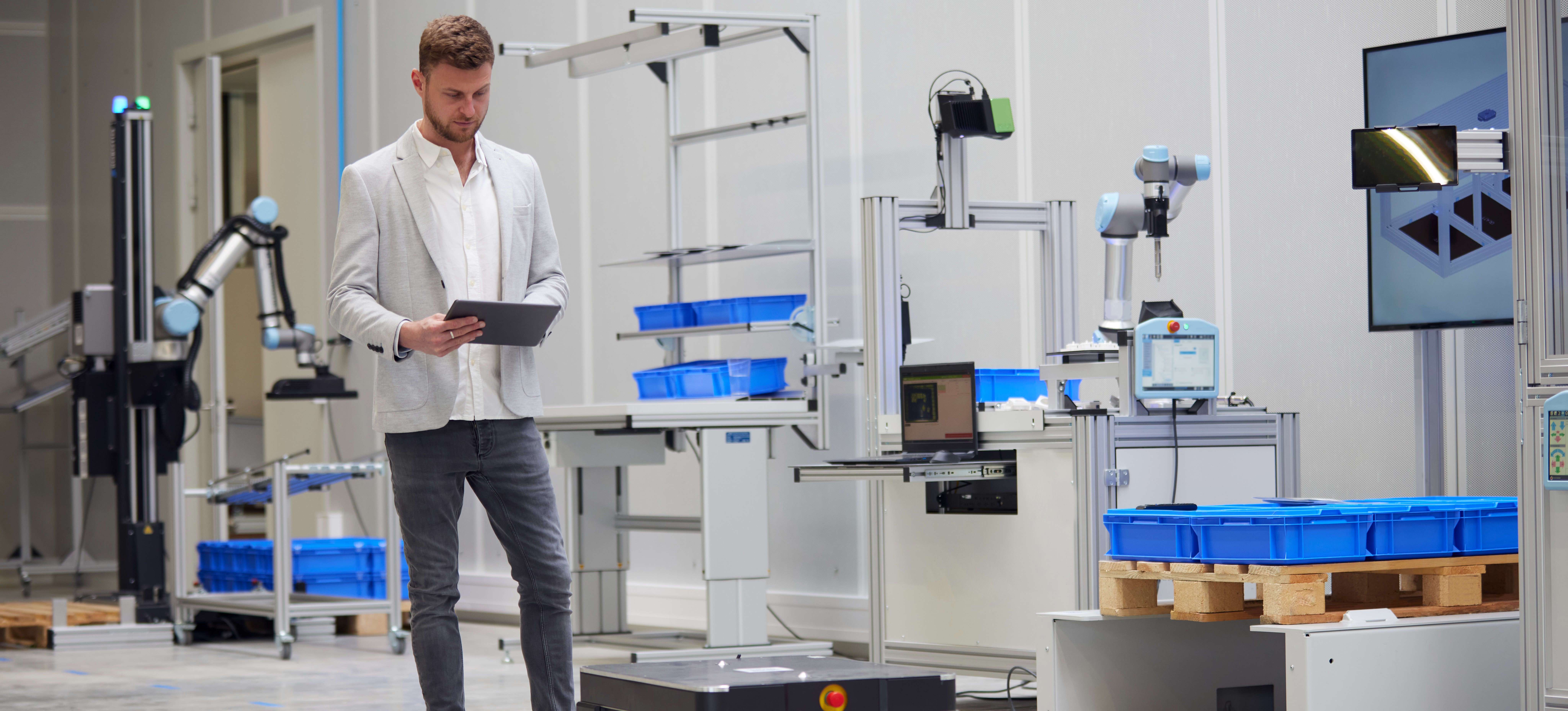 [Featured Image] A robotics engineer prepares an autonomous mobile robot for use.
