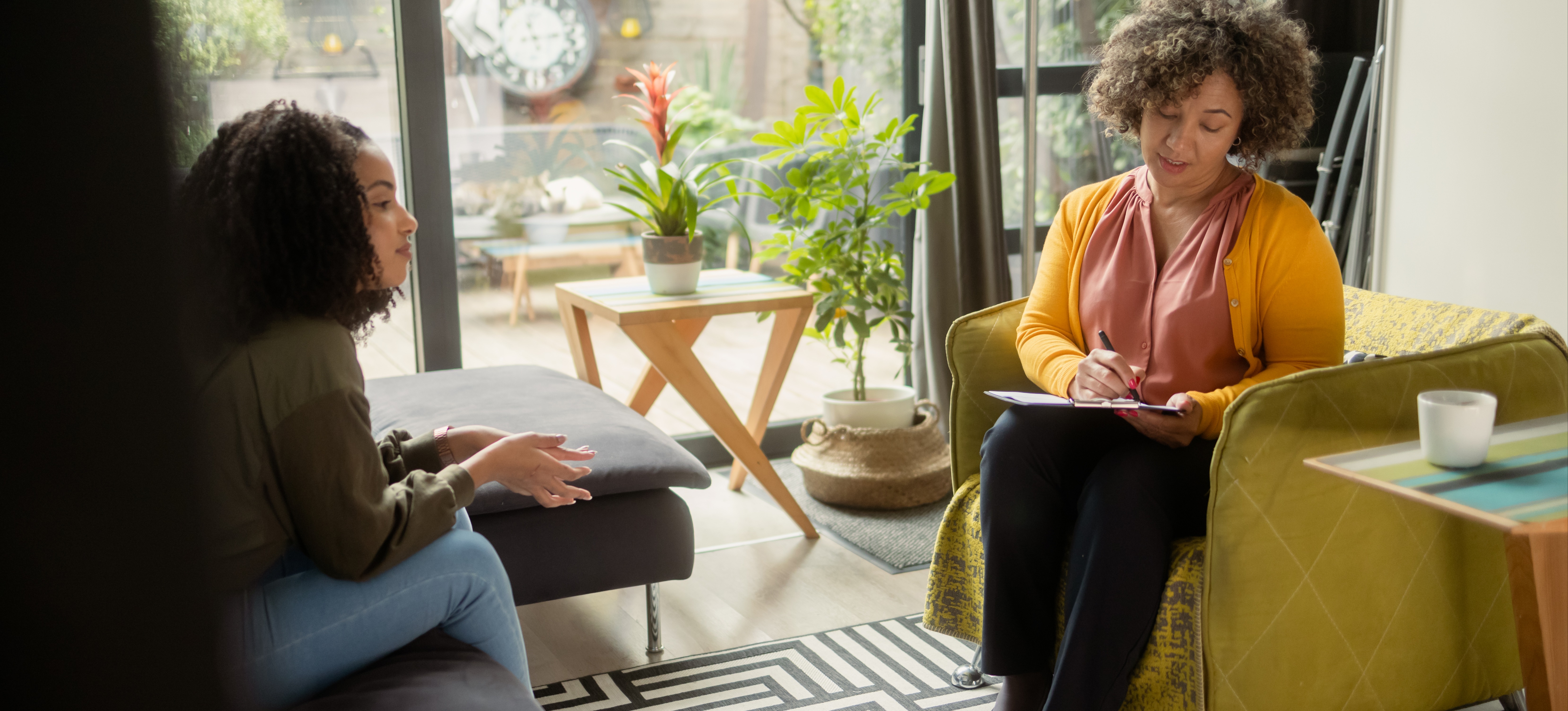 [Featured Image] A female school counselor sits across from a female student and explains what a diploma is.