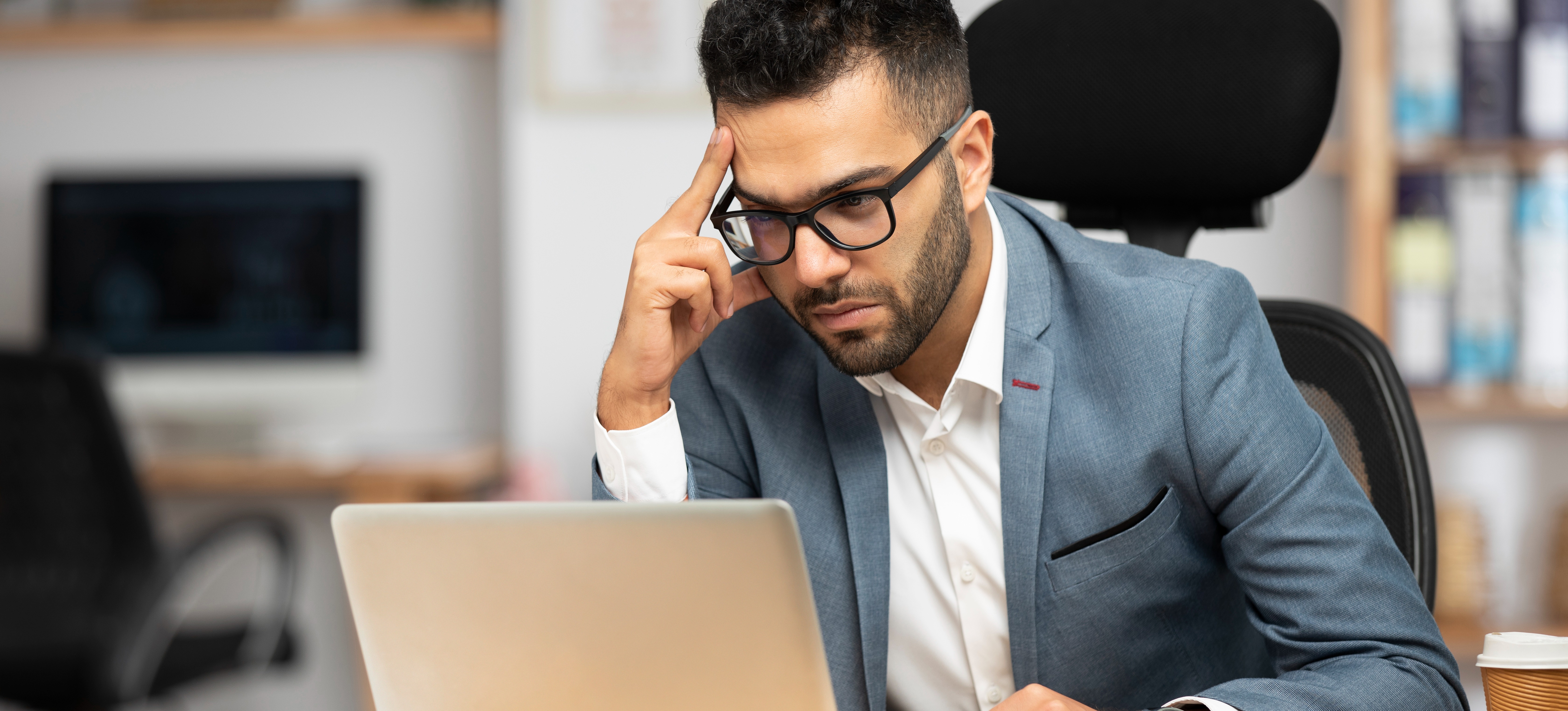 [Featured Image] A business analyst concentrates on the latest information and data on their laptop as they evaluate business processes. 
