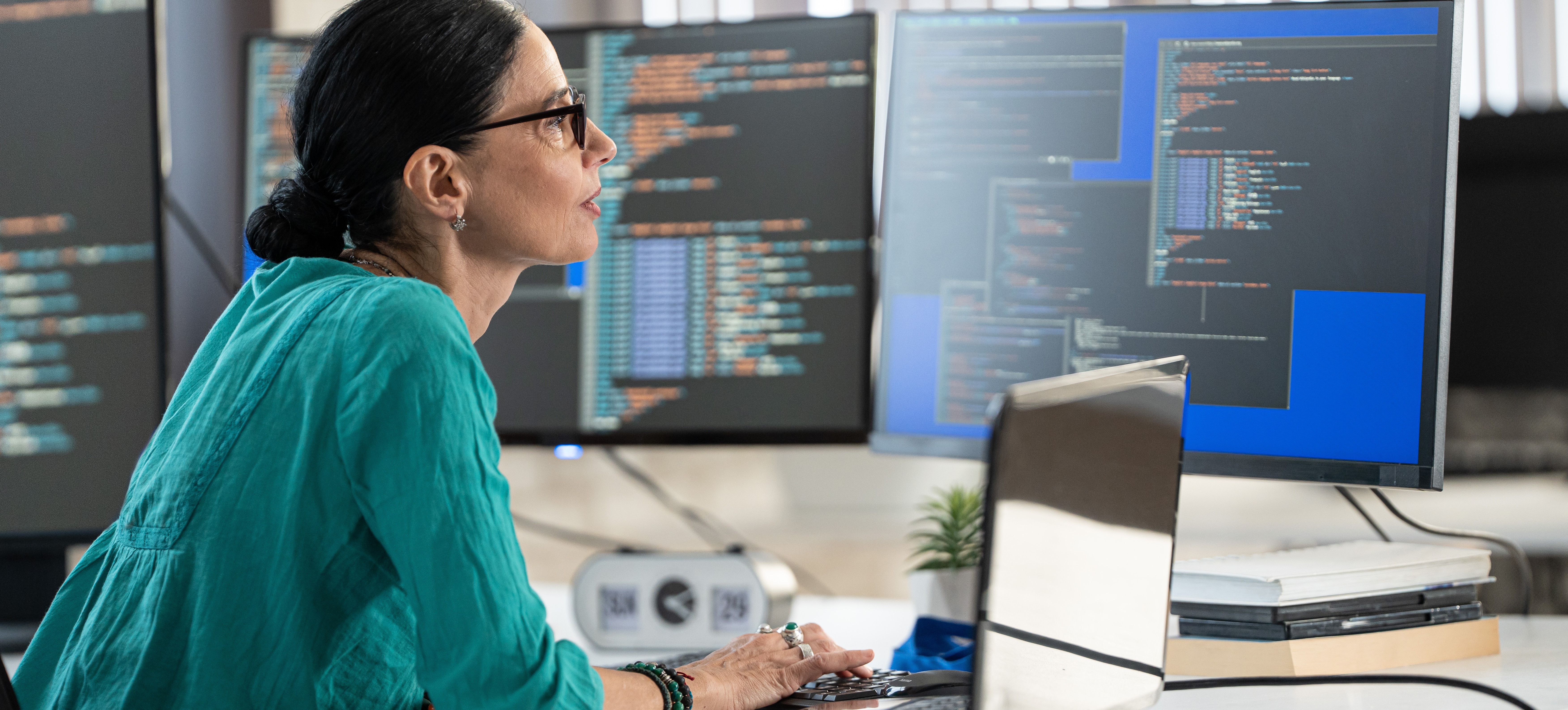 [Featured Image] A data scientist works with hyperparameter optimization in machine learning as they look at data on several computer monitors.