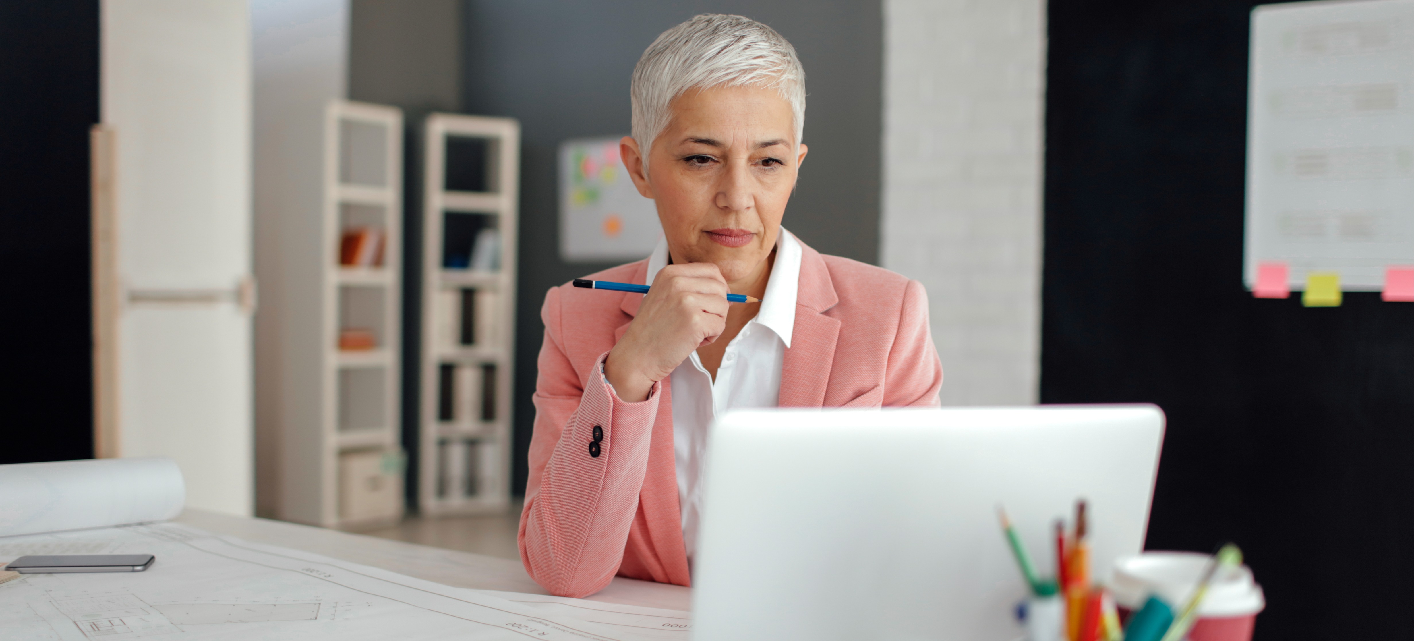 [Featured image] A person wearing a pink blazer sits at their desk, setting up their Google tags.