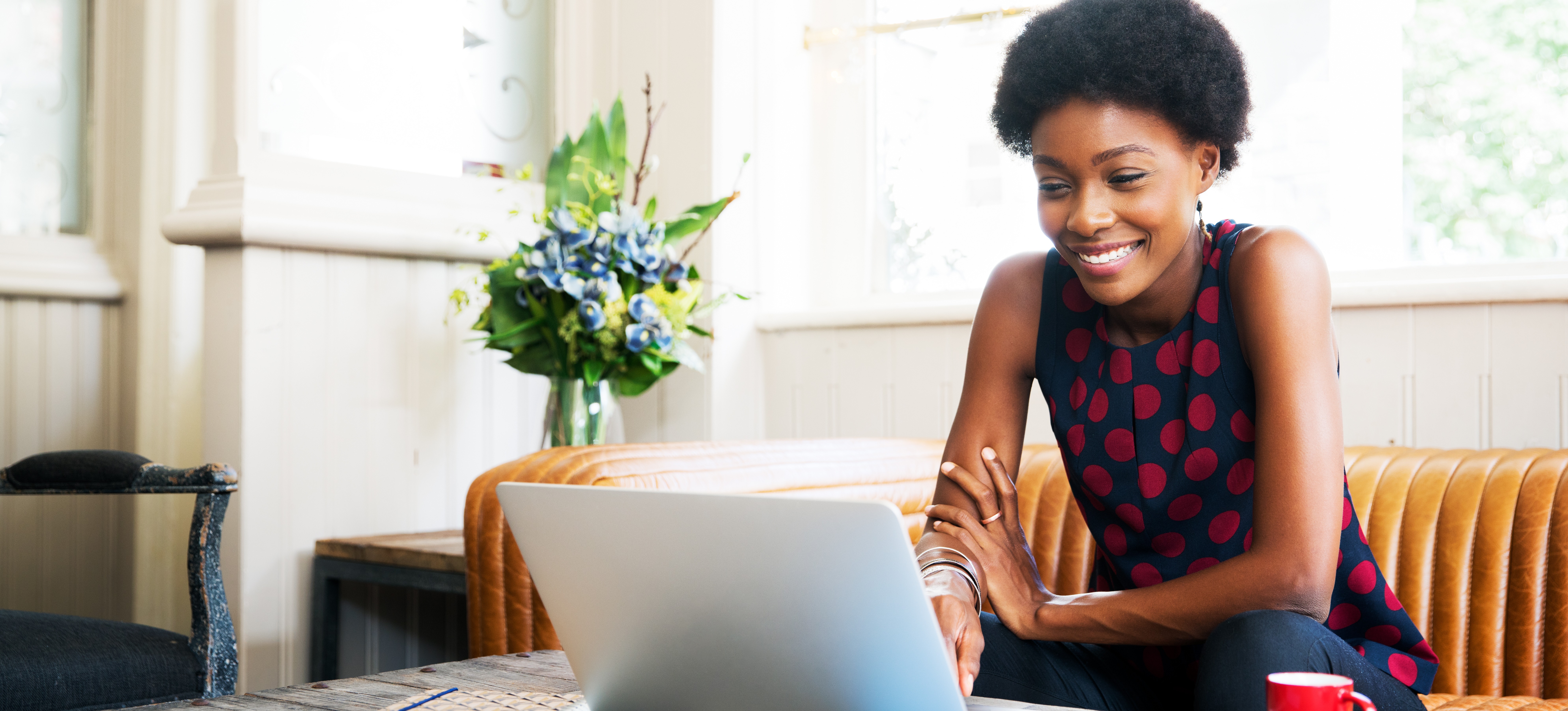 [Featured Image] A woman sits in a coffee shop, looking at her laptop, and considers taking an online course on how to learn data structures and algorithms.