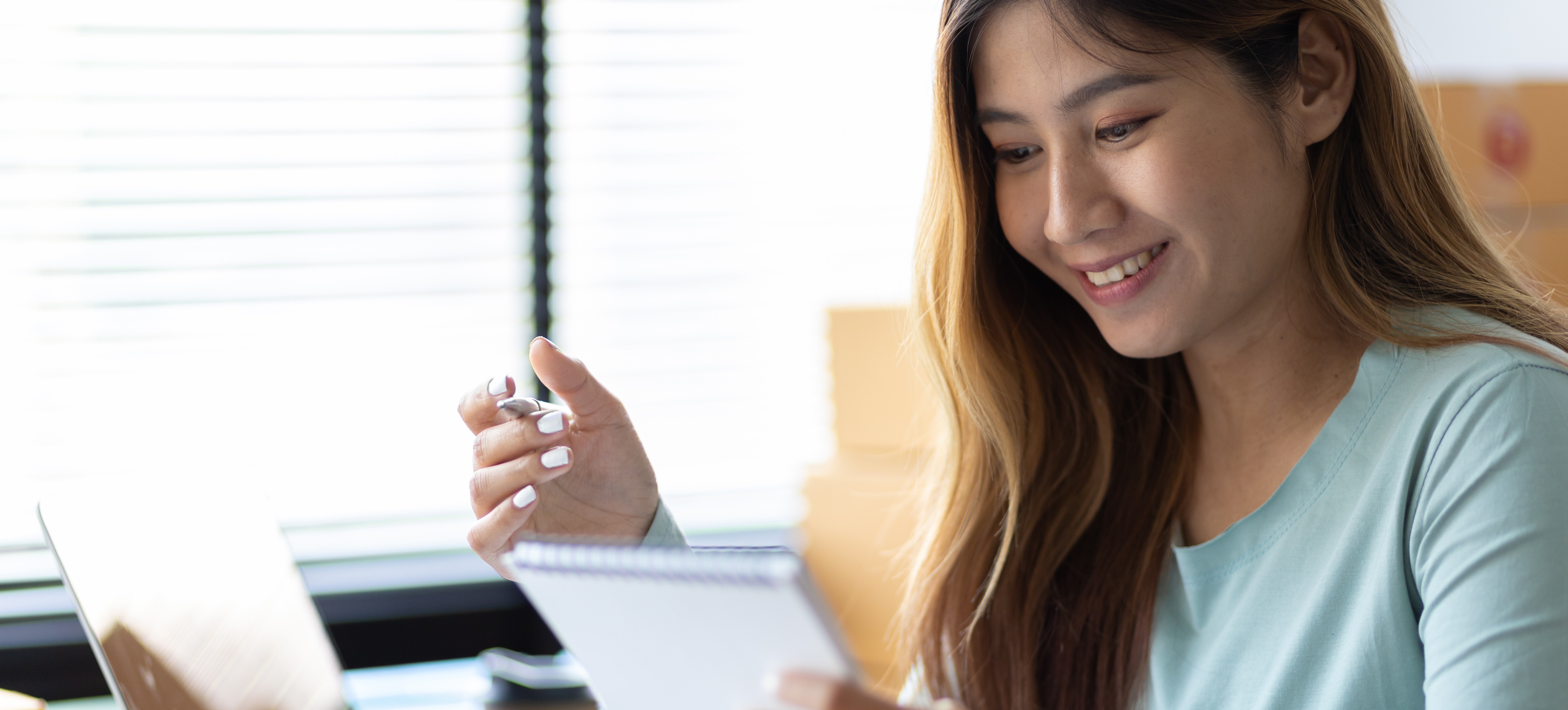 [Featured Image] A person sits at a workspace and creates a list as part of a chunking strategy.