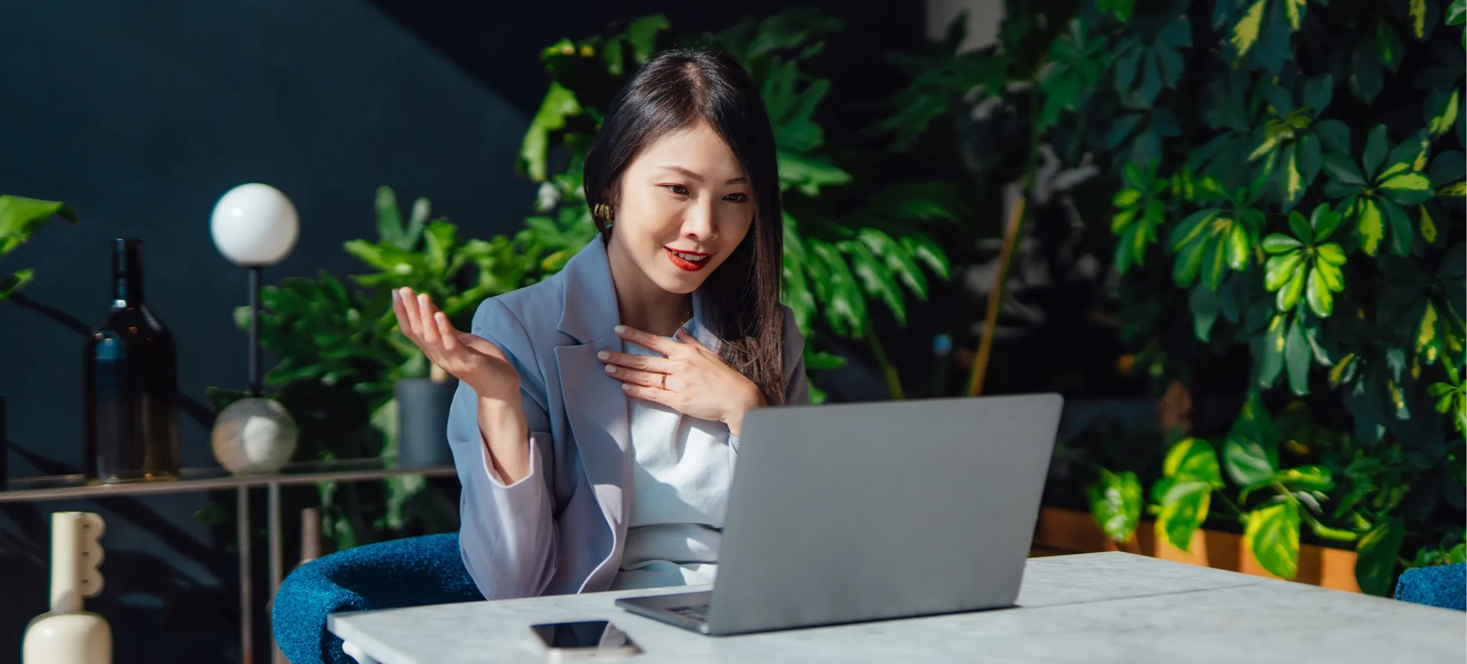 [Featured Image]: A person uses an AI chatbot on a laptop to find answers to questions like "What is Grok?"
