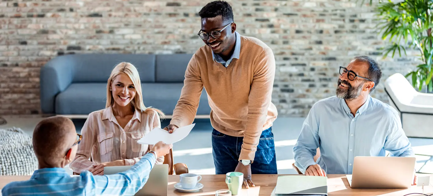 [Featured Image] An HR team meets to discuss the results of the people analytics data they have gathered for the quarter. 
