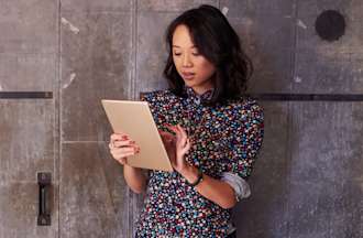 Project manager checks team progress on her tablet