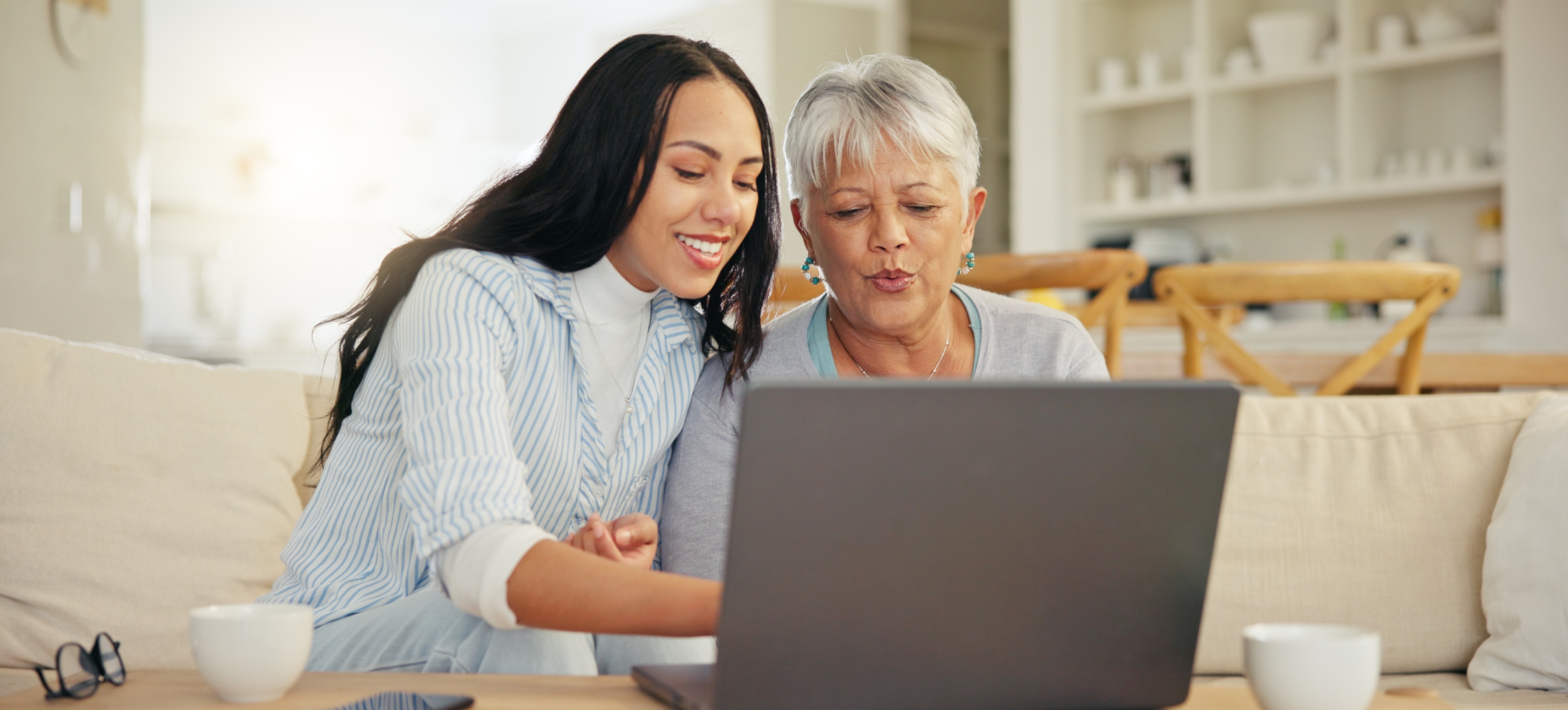 [Featured Image] A young computer user explains how network interface cards work to allow their parent’s laptop and other devices to connect to the network. 
