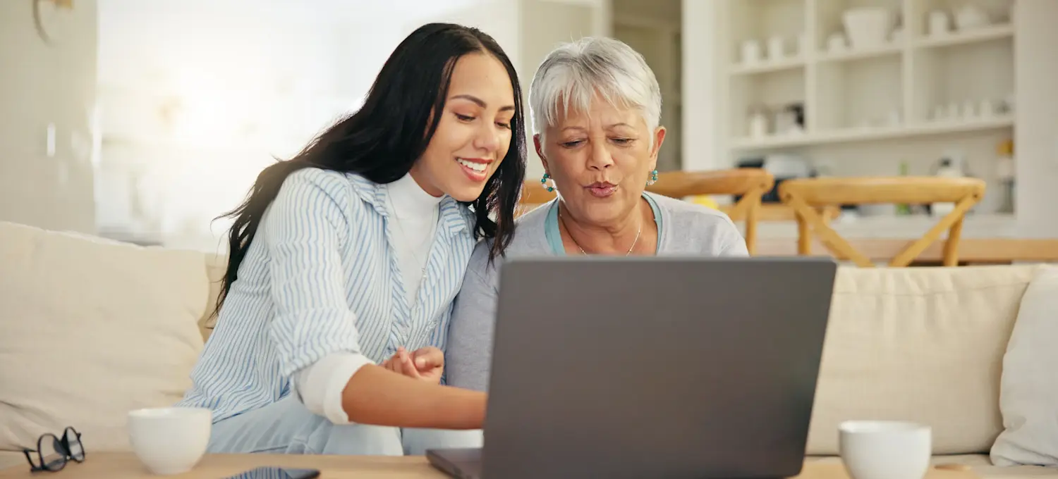 [Featured Image] A young computer user explains how network interface cards work to allow their parent’s laptop and other devices to connect to the network. 
