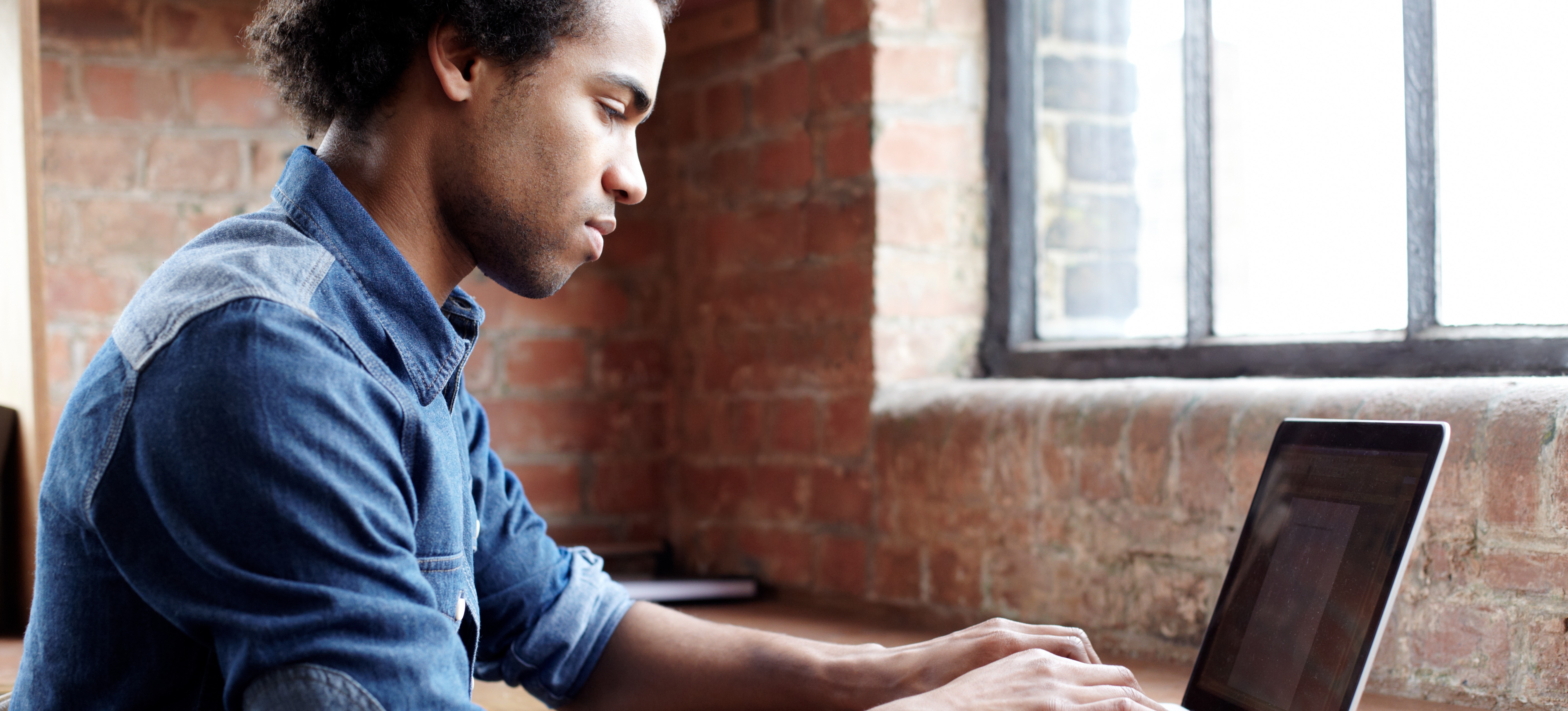 [Featured Image] A person is typing on their laptop, creating an artificial intelligence resume.
