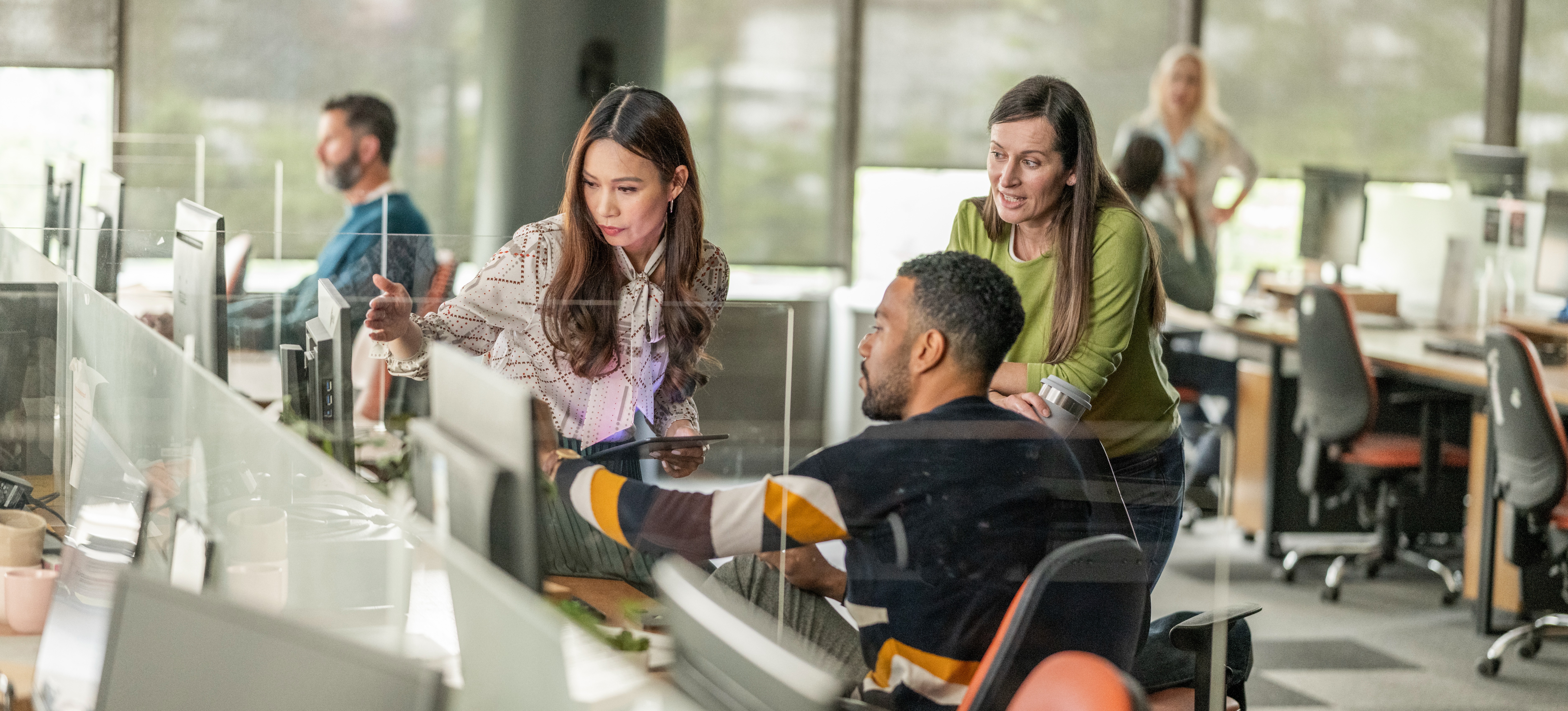 [Featured image] A team of three data analysts in a bright office, using predictive analytics tools to consider future trends.
