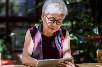 [Featured image] An IT support specialist is sitting outside learning about CIDR on their tablet. 