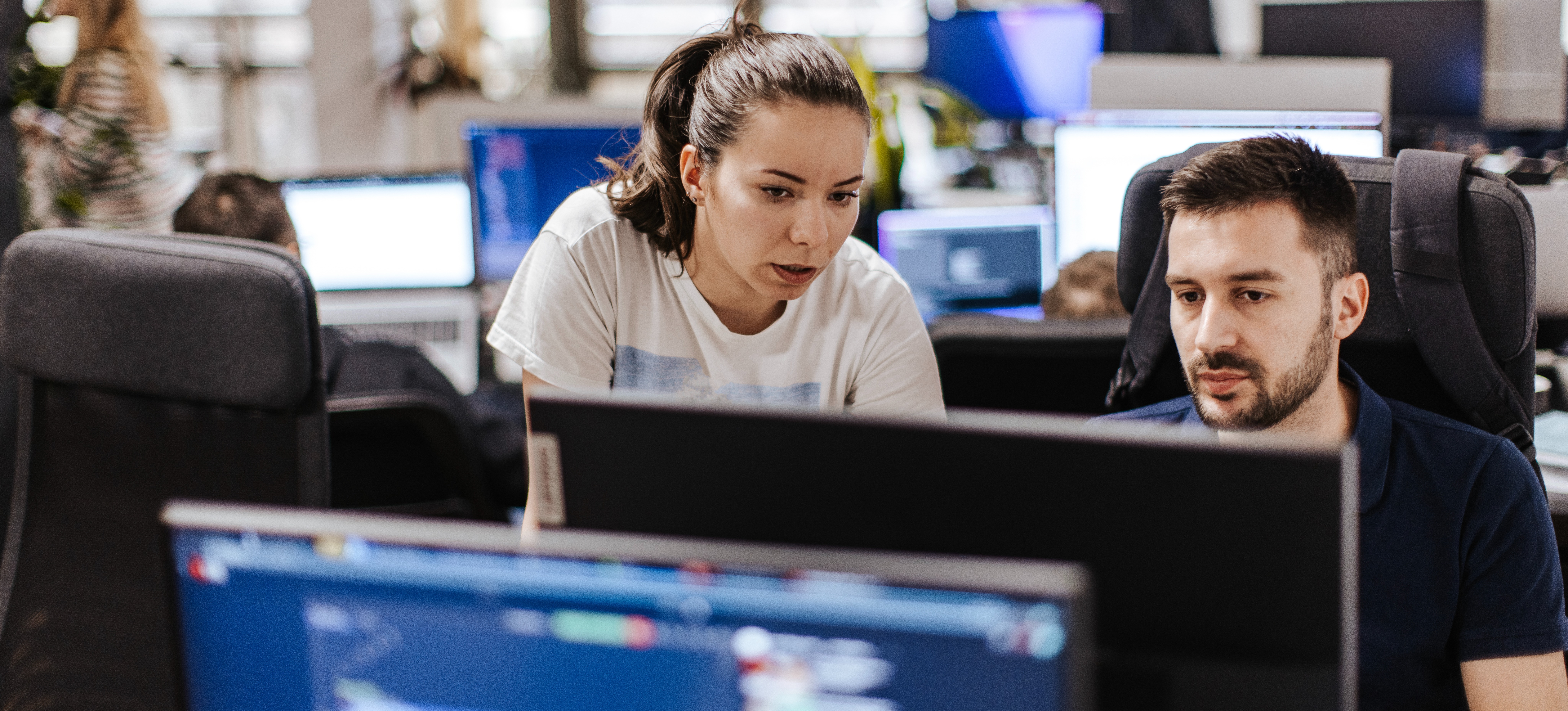 [Featured Image] Two deep learning specialists look at computer screens and discuss LLM training.
