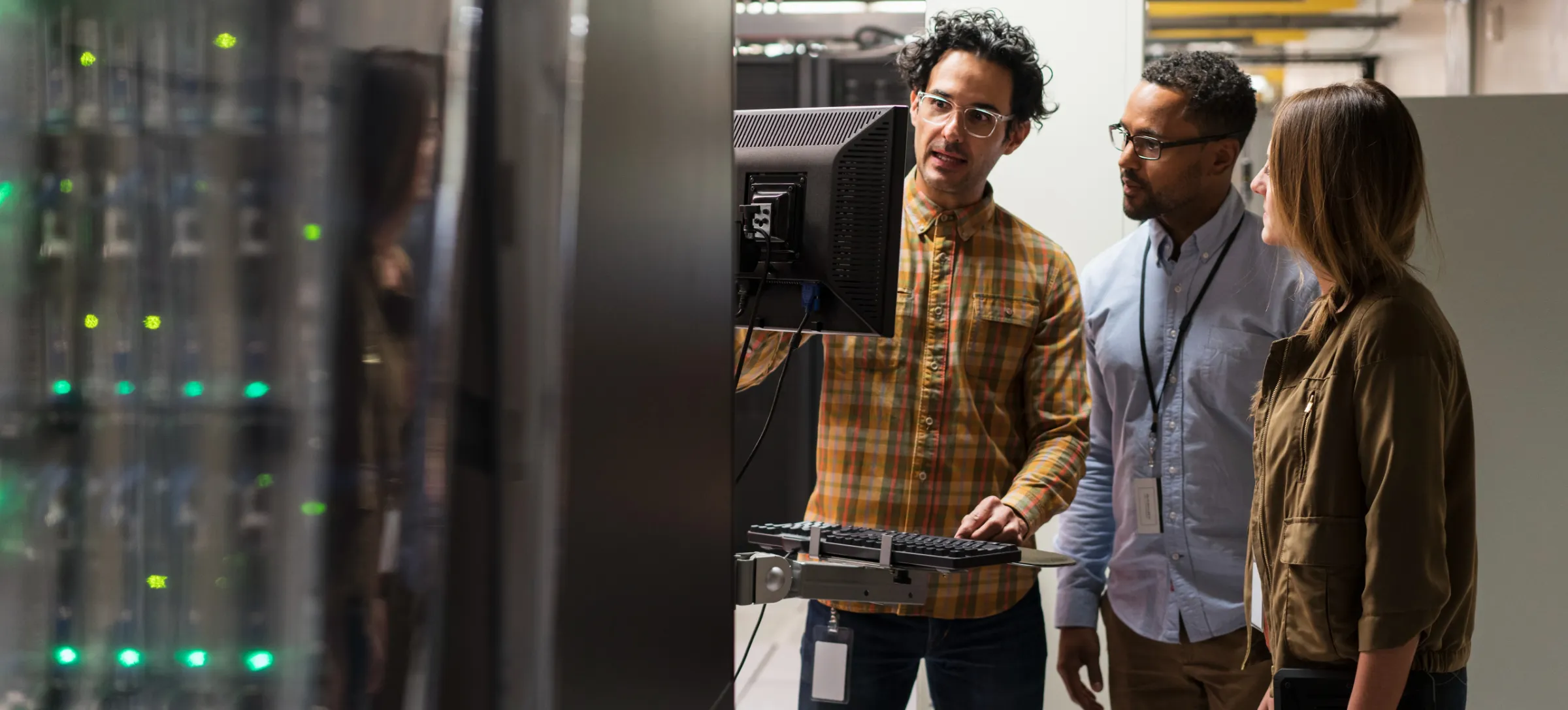 [Featured image] Three people stand around a computer in a server room discussing ephemeral ports.