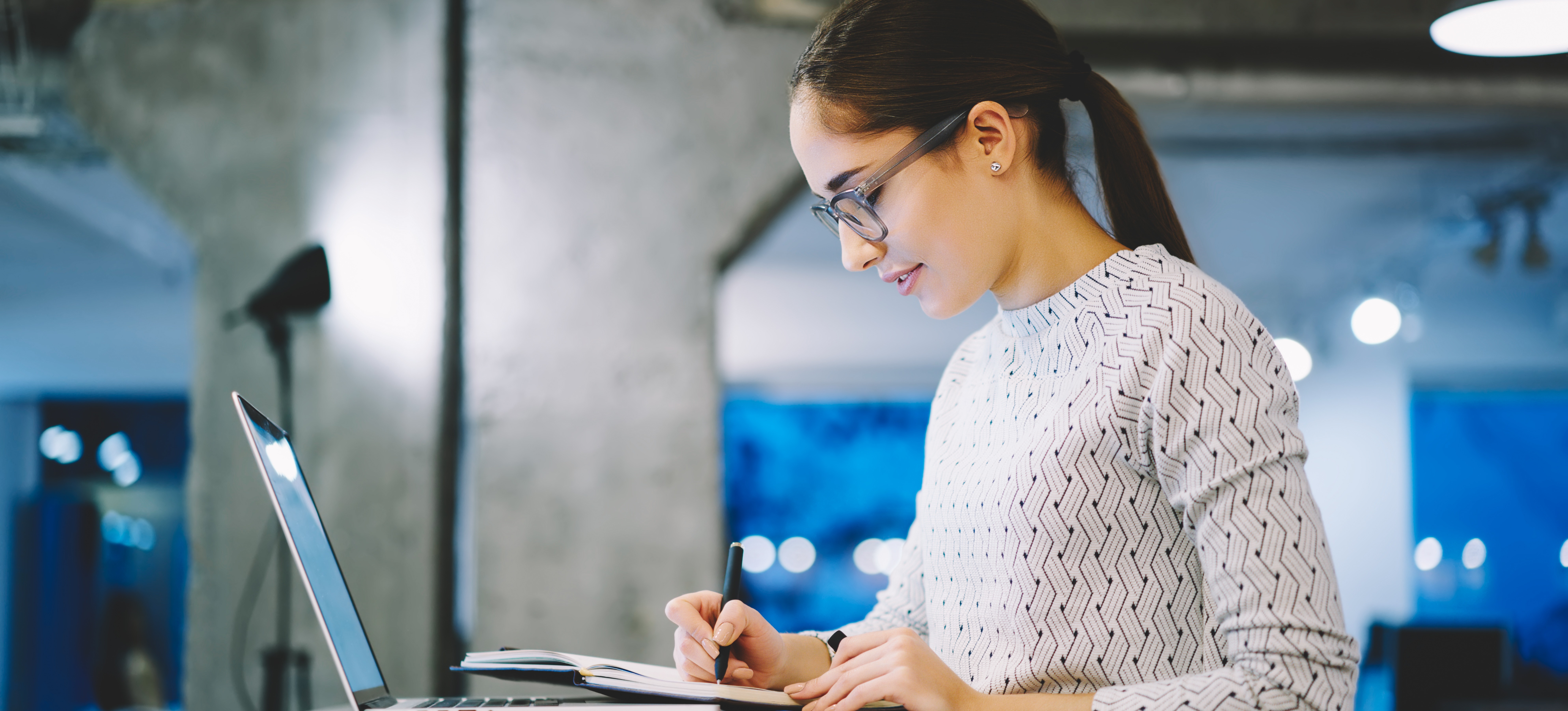 [Featured image] A person with a laptop computer and a notebook is taking notes for a Bachelor of Health Science degree.