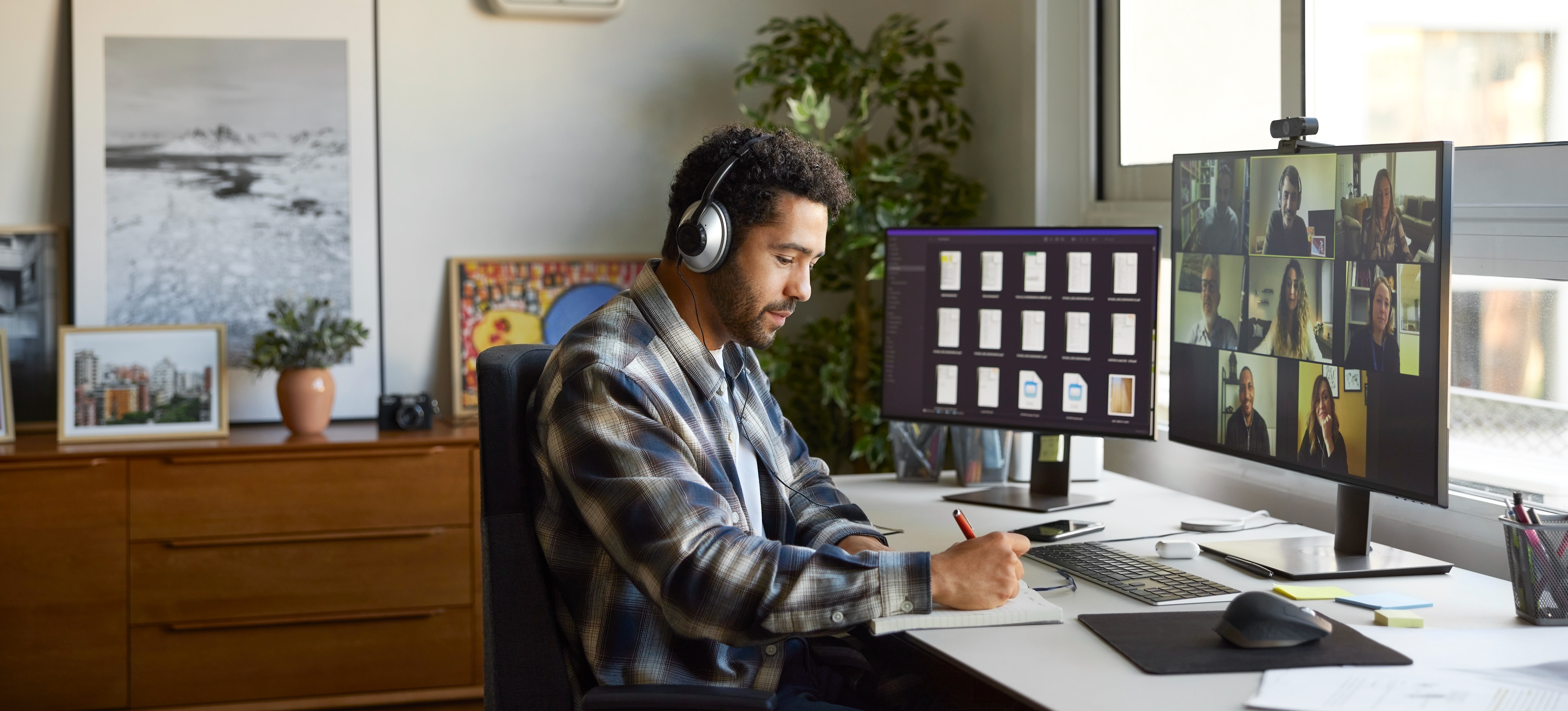 [Featured image] A project manager meets with stakeholders on a video conference call to update them on a project.