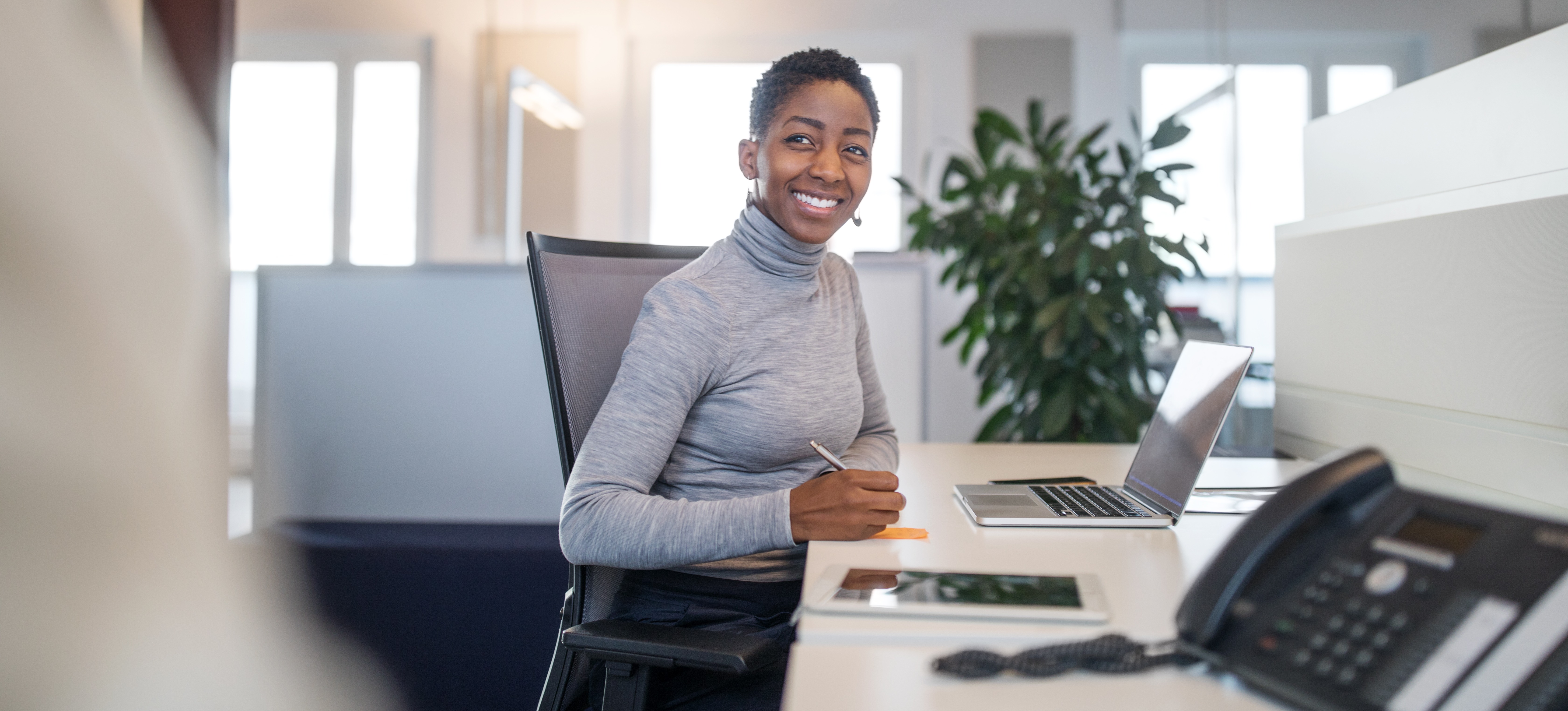 [Featured Image] A person sits at a reception desk.