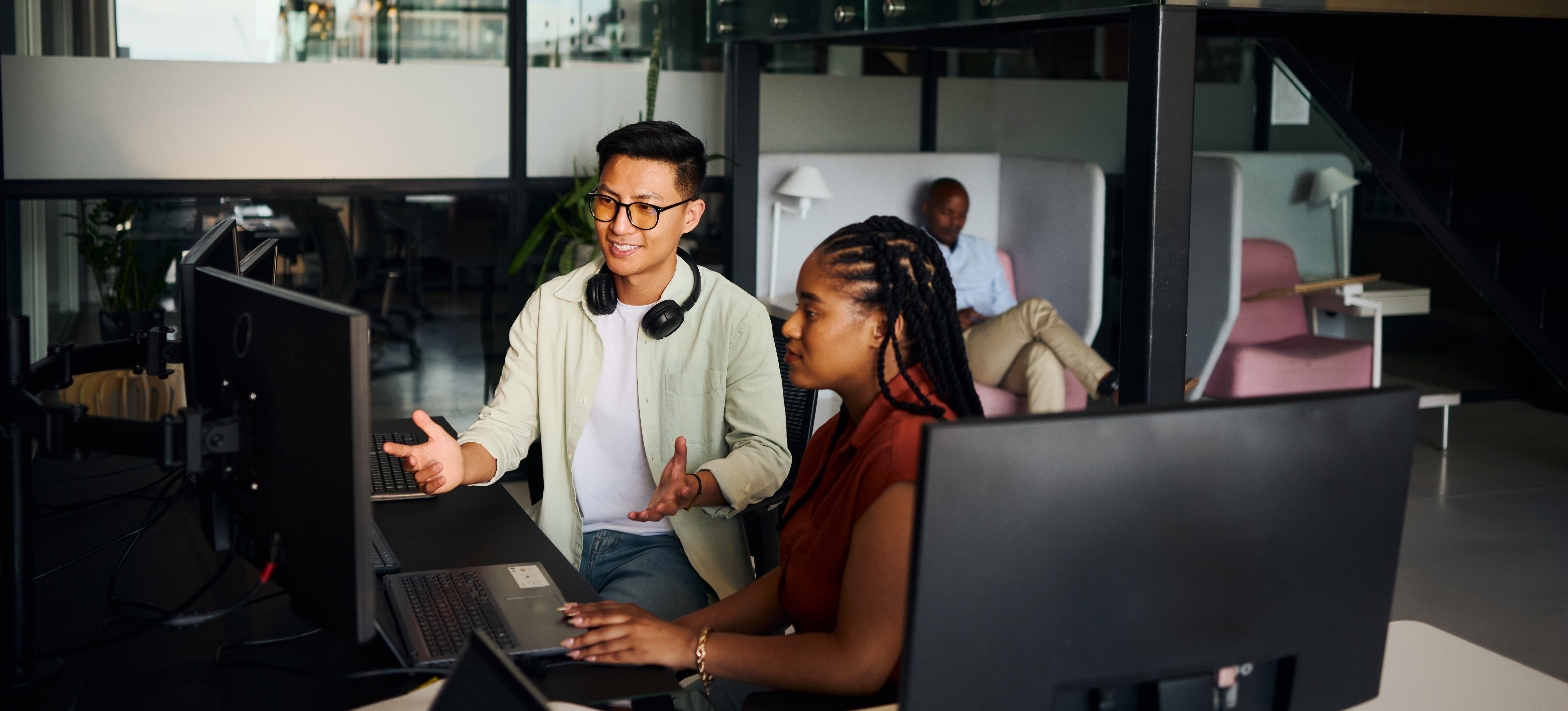 [Featured Image] Computer support specialists in a workspace, interacting with each other while discussing certification topics.
